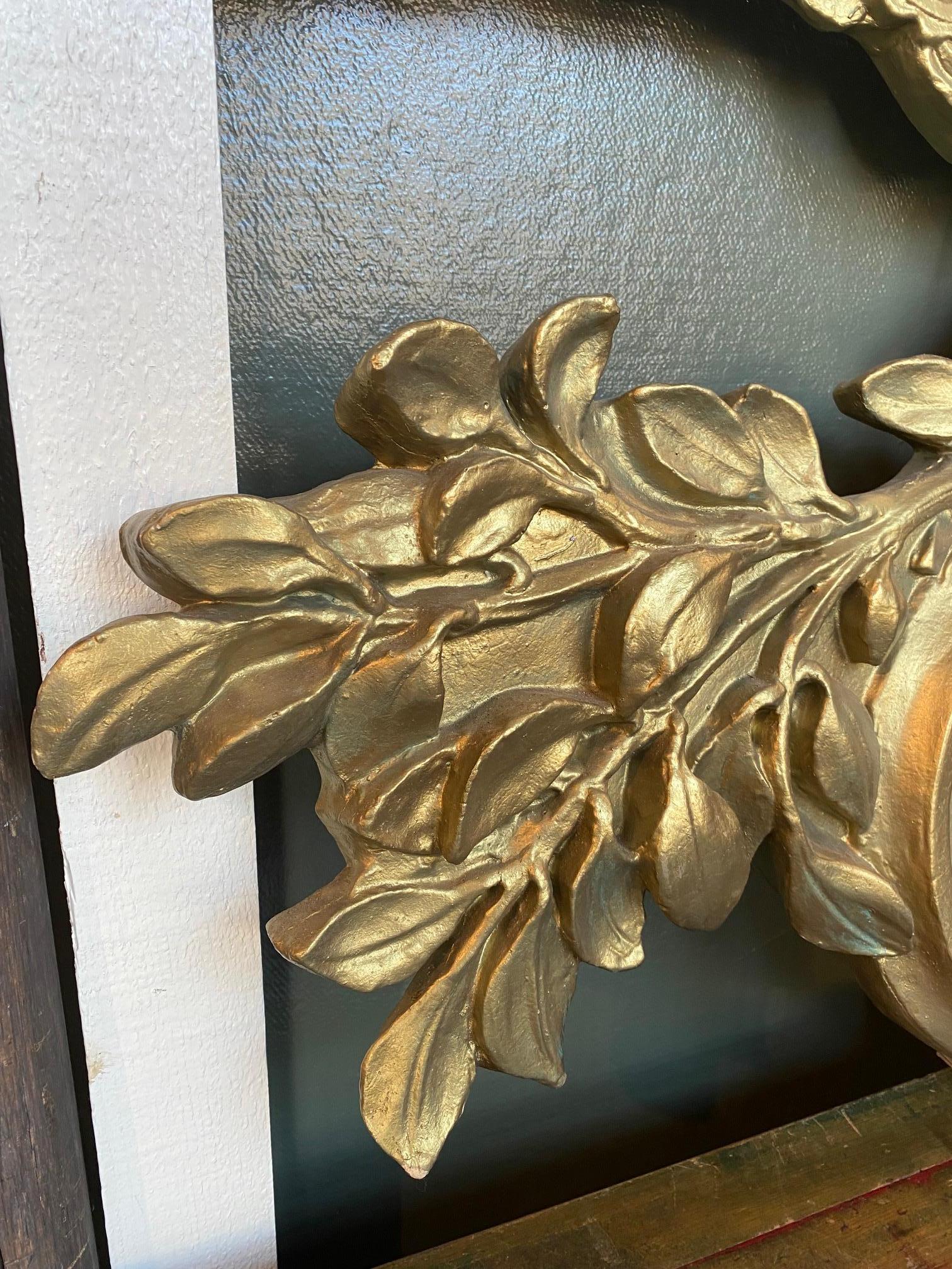 Cast and Gilded Patriotic Eagle with Clipper Ship Plaque, with a Clutch of Arrows and an Olive Branch in it's Talons, mid 20th Century, from a Boston Bank associated with the historic State Street Trust Bank. The Bellamy type spread-wing eagle holds