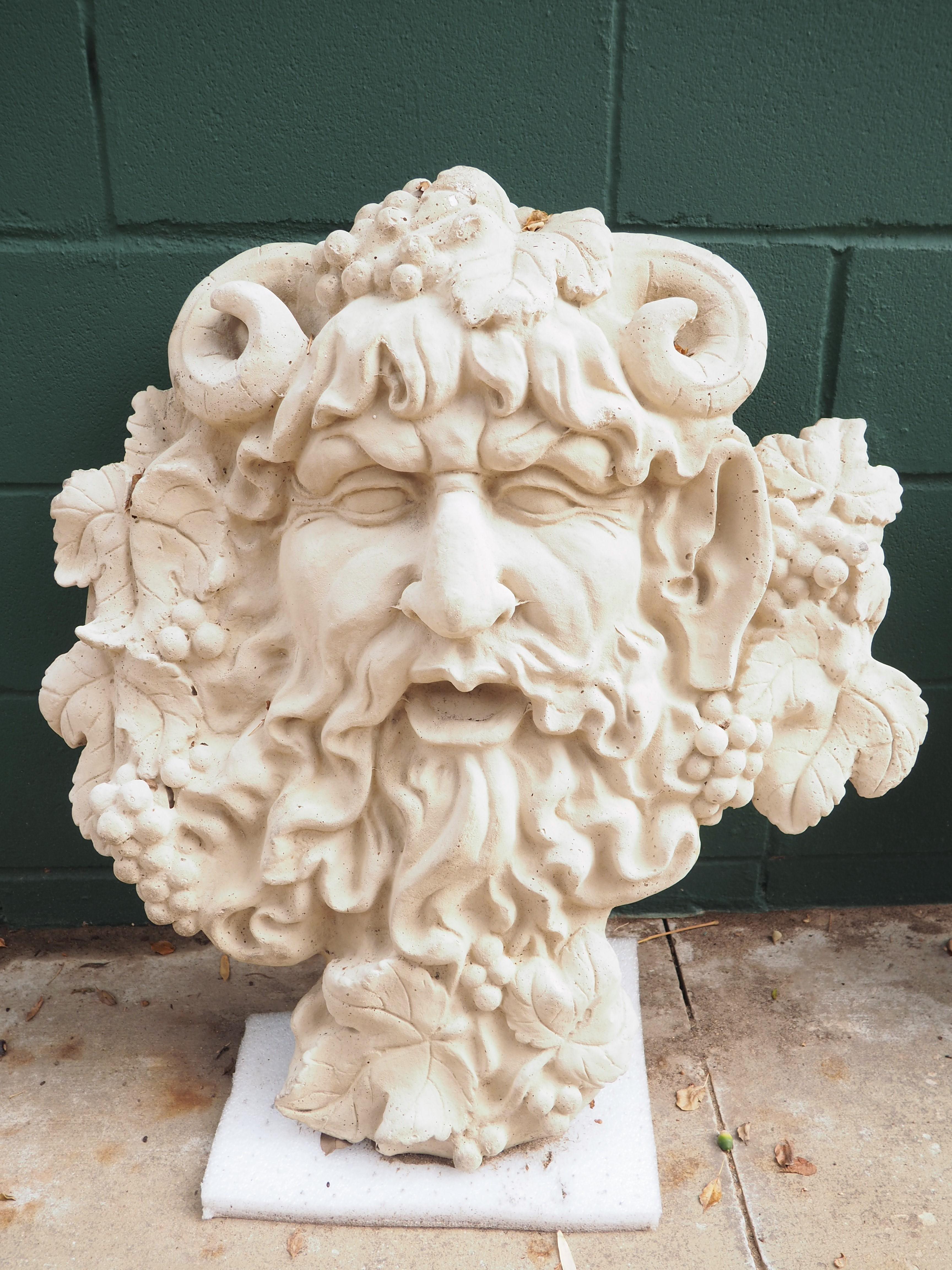 Cast in France, using a mixture of pulverized stone and cement, this large wall hanging of Bacchus, God of Wine, can also be used as a fountain spout. The stone and cement mixture, which is known as reconstituted stone, has also been mixed with a