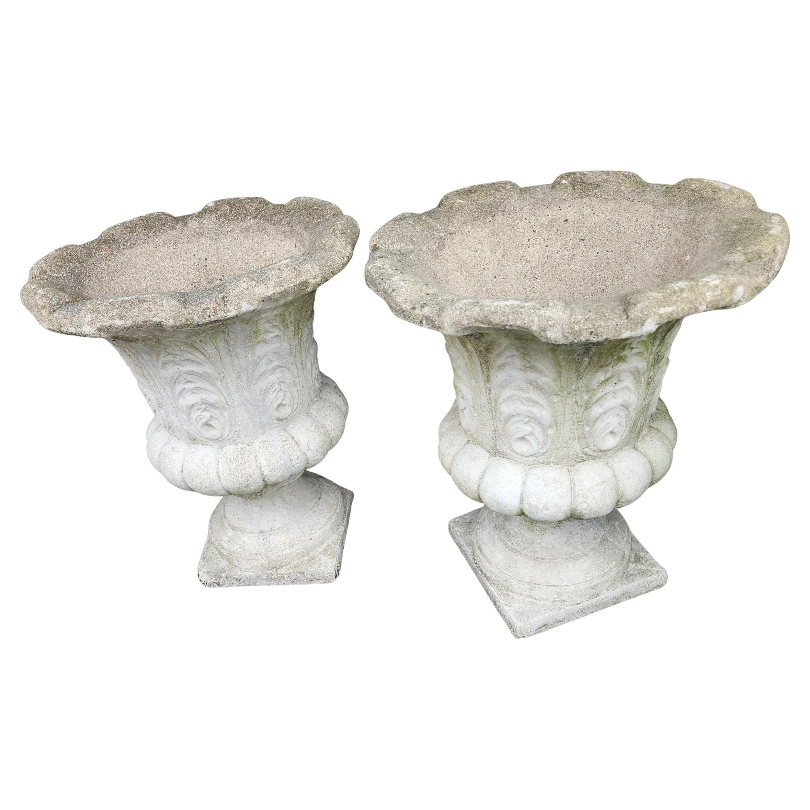Fabulous cast stone urns or planters. Almost 2 ft tall x 19 wide at the top with flared edges.
Acanthus leaf impressions all the way around
with a ribbed base. Have 3 available.  In very good condition with normal age related wear. Priced and sold