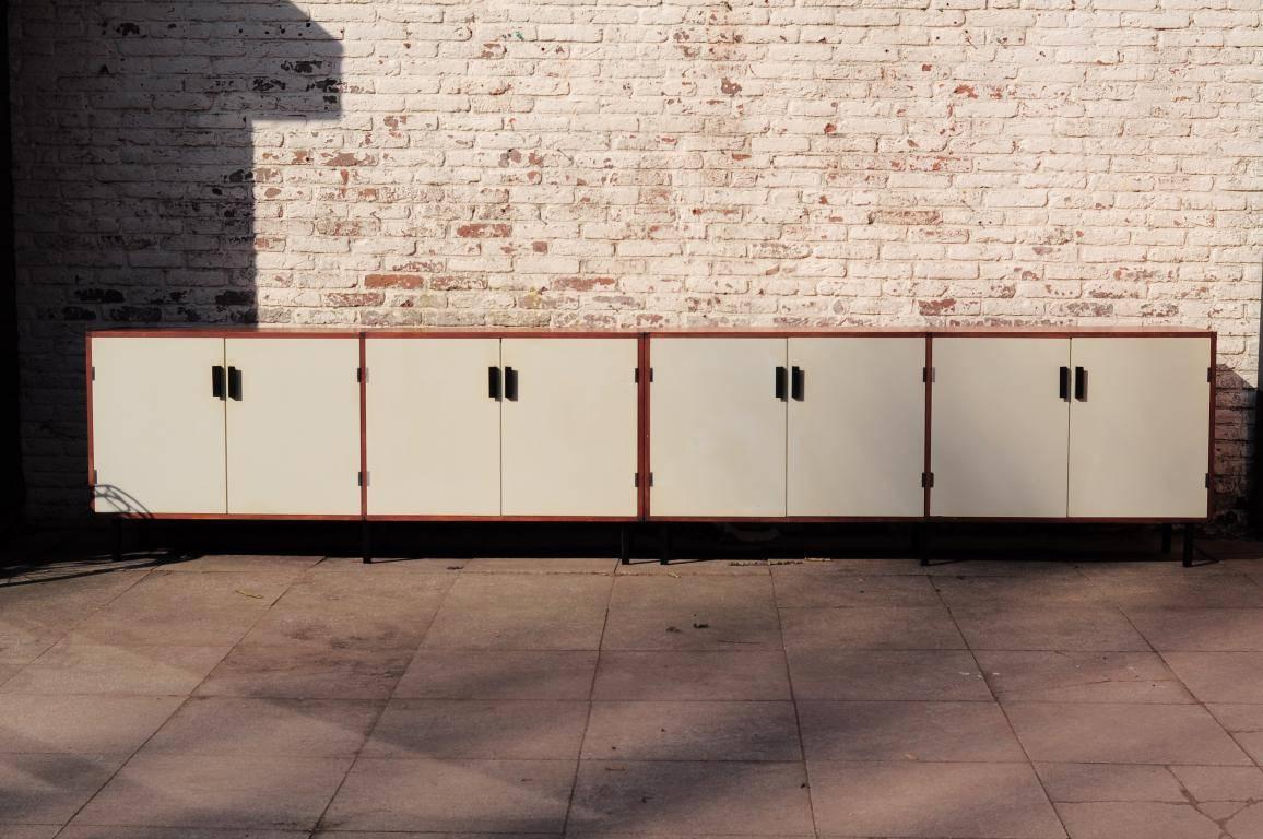 Set of two credenza's which creates one large Cees Braakman for Pastoe “Made to Measure” credenza of total 370 cm!

Teak veneer with white spray painted doors. In good condition, only a a small damage in one white door.

Measures: Length 185cm