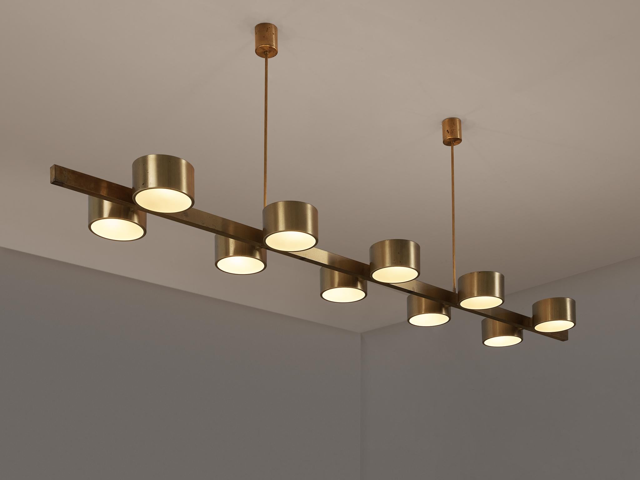 Hans-Agne Jakobsson, produced in Markaryd, ceiling light, 'model T 261/10', brass, frosted glass, Sweden, 1960s measures: 8.5 ft. 

Hans-Agne Jakobsson designed this large chandelier with ten cylindrical light shades paired on a line. The brass