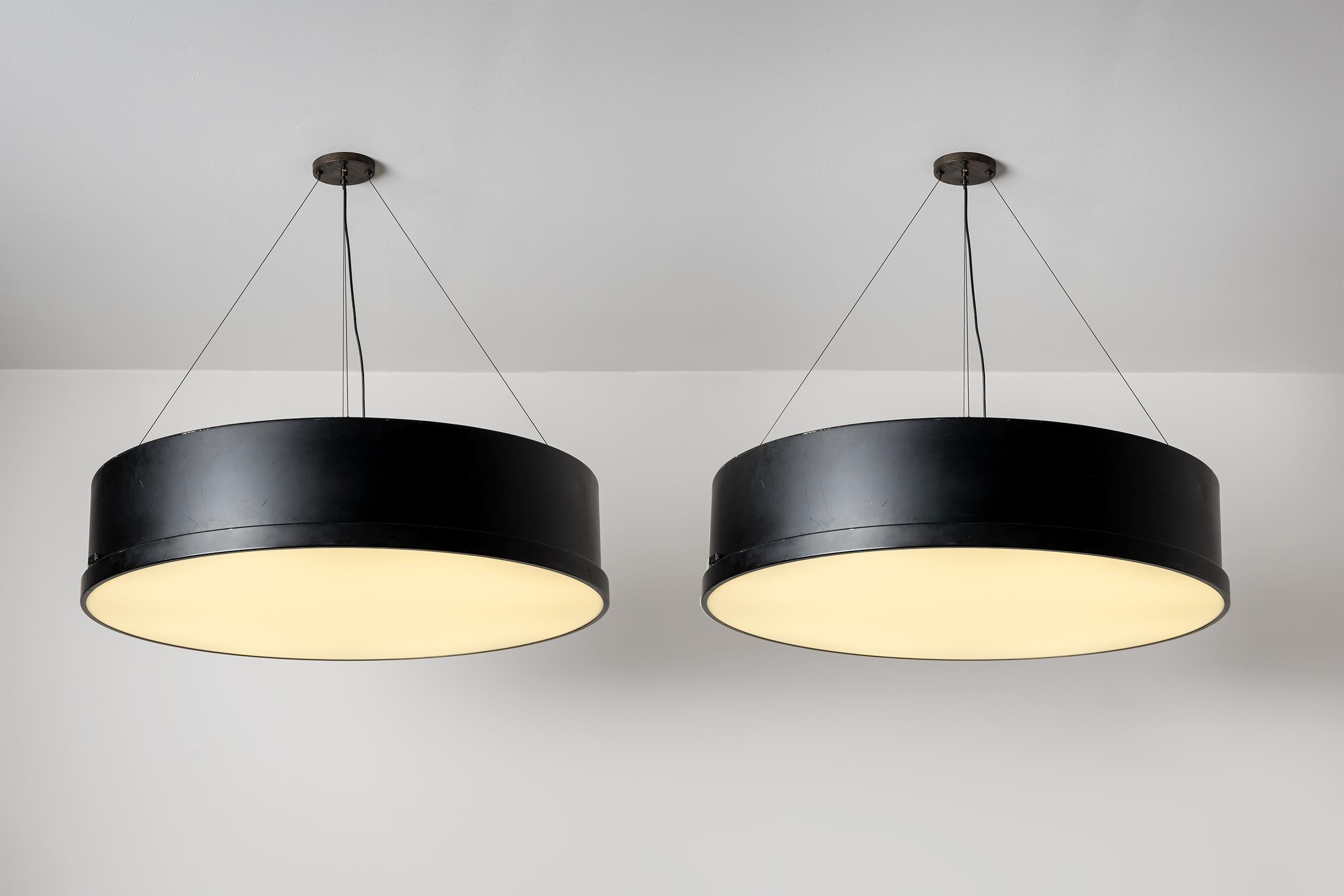 Large custom pair of ceiling lamps with lacquered metal structure and plexiglass diffuser. Designed by Bruno Gatta for Stilnovo. Produced in Italy, circa the 1950s. Each drum consists of ten fluorescent tubes. Wired for US standards. Priced and sold