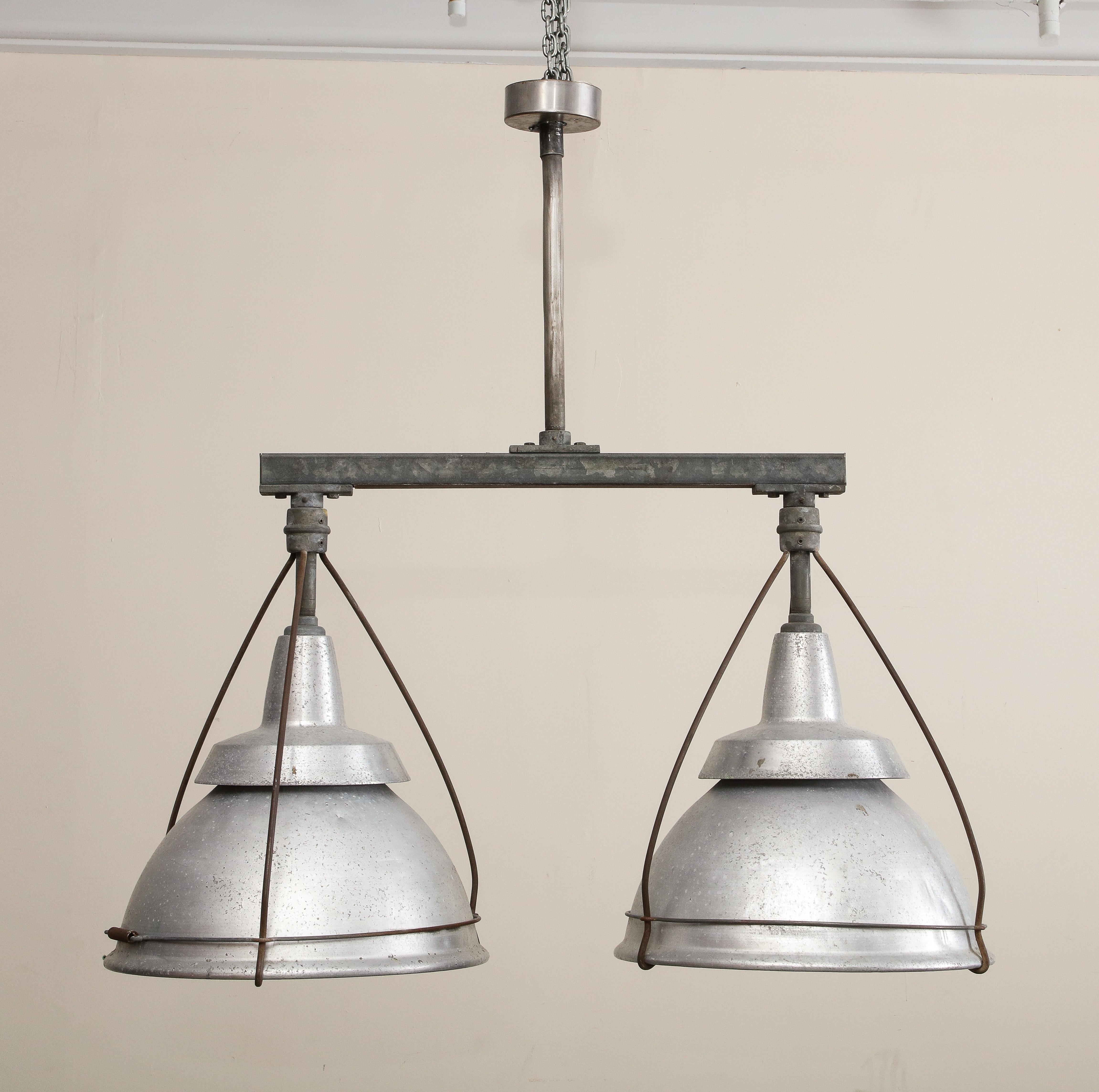 Large industrial double pendant light, c. 1920. Ceiling mounted single canopy, wired for USA and in working condition. 

44