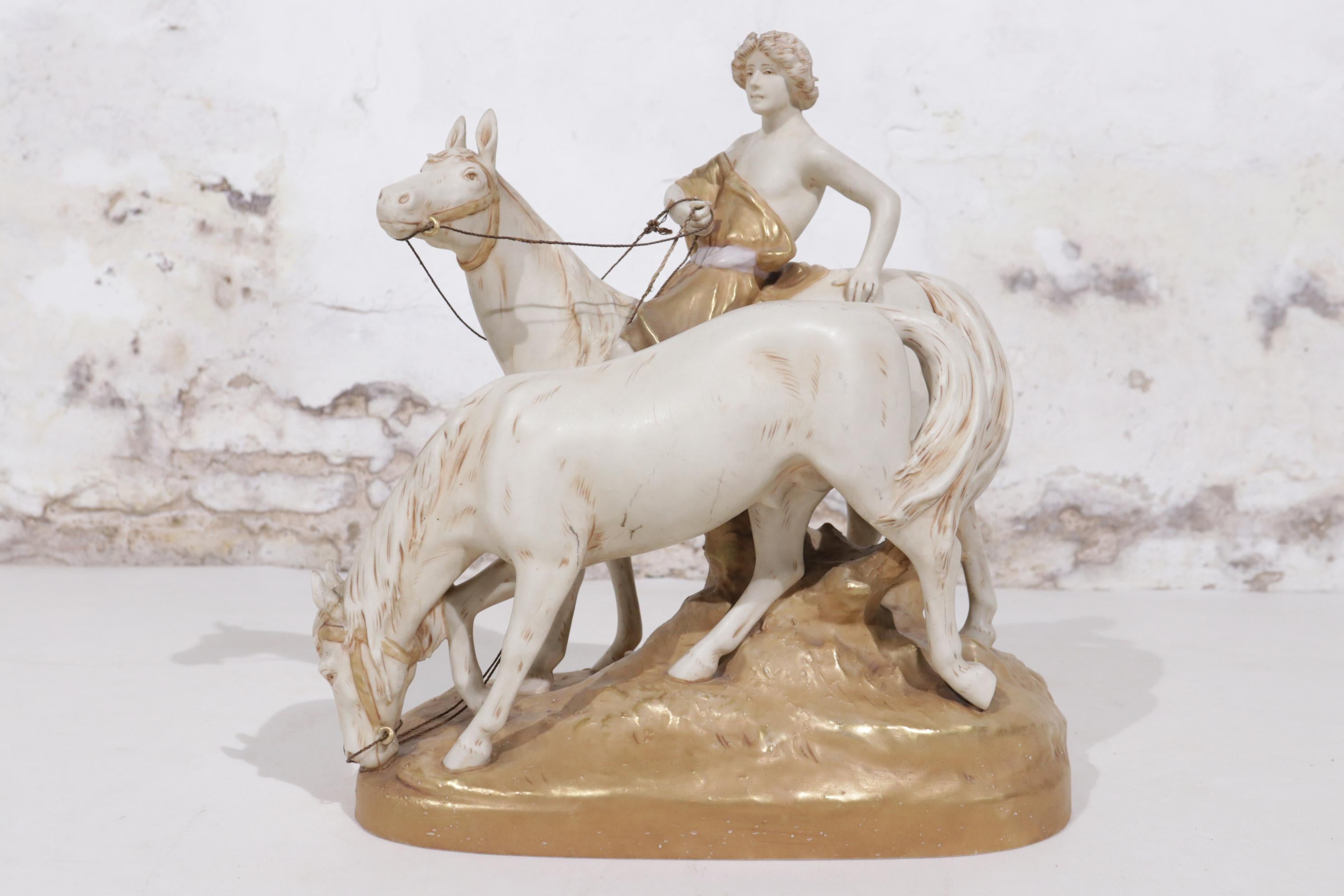 Stunning Large Centerpiece made by Royal Dux in around 1910.
A boy riding a horse and holds the other horse by hand.
Beautiful pearl white and cold colours.
 