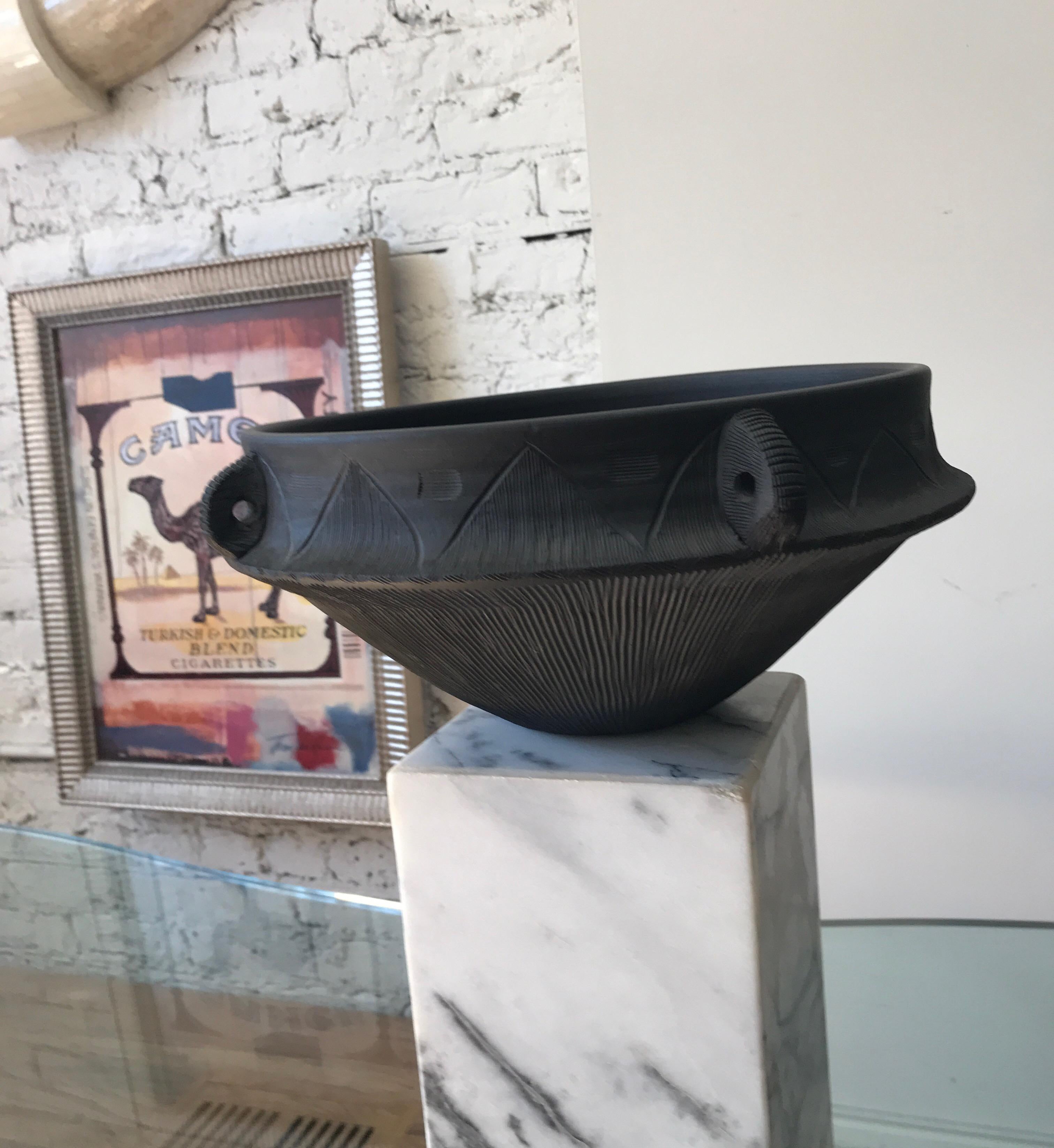 Ceramic black matte large midcentury decorative bowl. The bowl has an overall incised decoration.
Its richly textured surface is reminiscent of a Classic 19th century wedge wood basalt bowl.
Signed Dagress to the underside.
The pedestal is not
