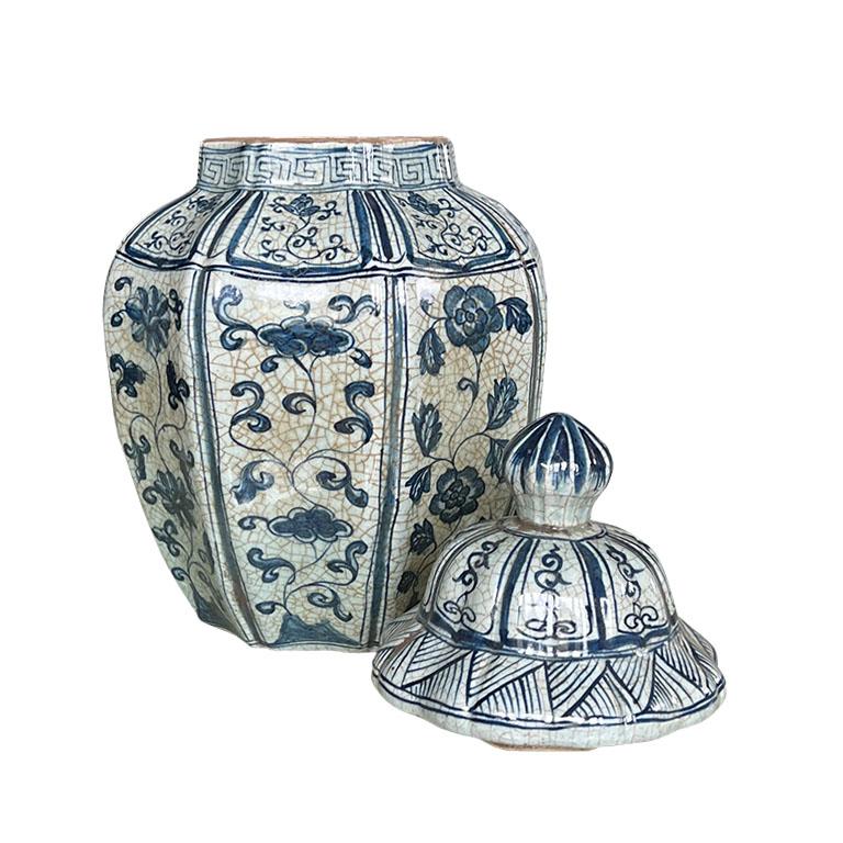 A large glazed ceramic ginger jar with lit. A great urn to add to a current grouping, or to accent a mantle or credenza. Glazed in a beautiful craquelure blue and white, it is decorated throughout with a floral motif with a geometric greek key