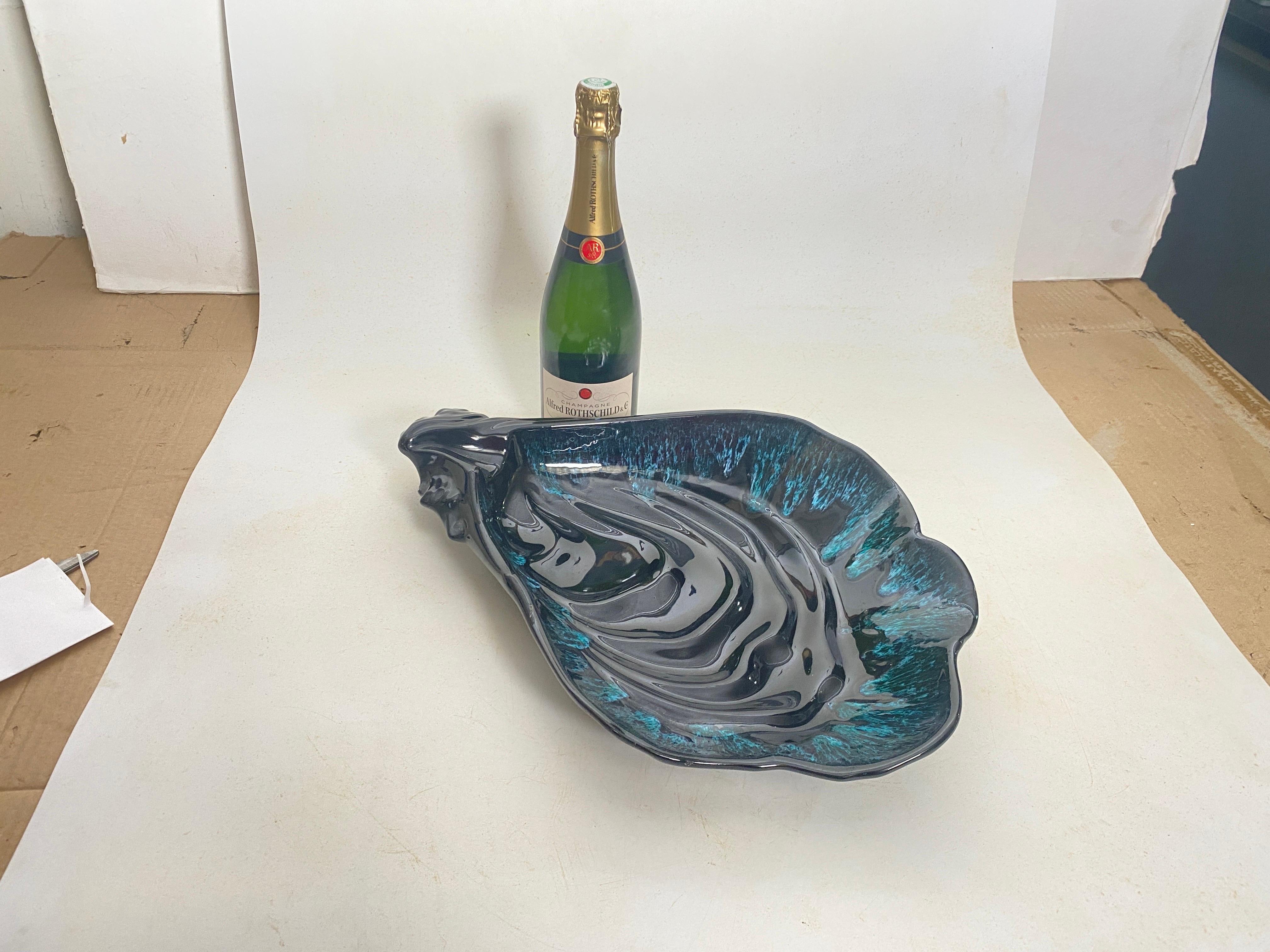 This Ceramic Central piece or Vide Poche, has a shell Shape. The colors are the blue.
It has been made in France Circa 1960
