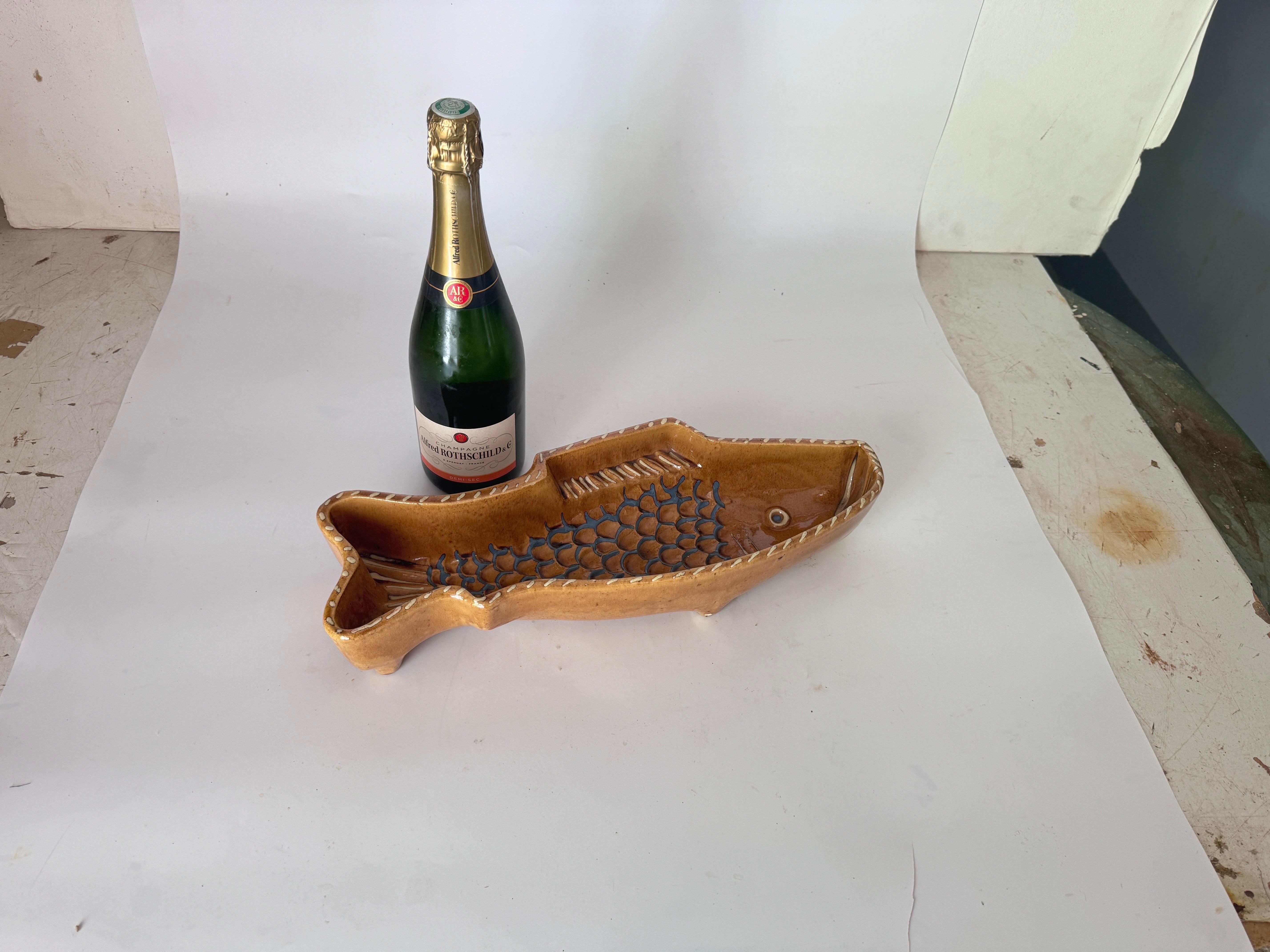 This Ceramic Ashtray or Vide Poche, has a Fish Shape. The colors are the Brown white and black.
It has been made in Italy Circa 1960
