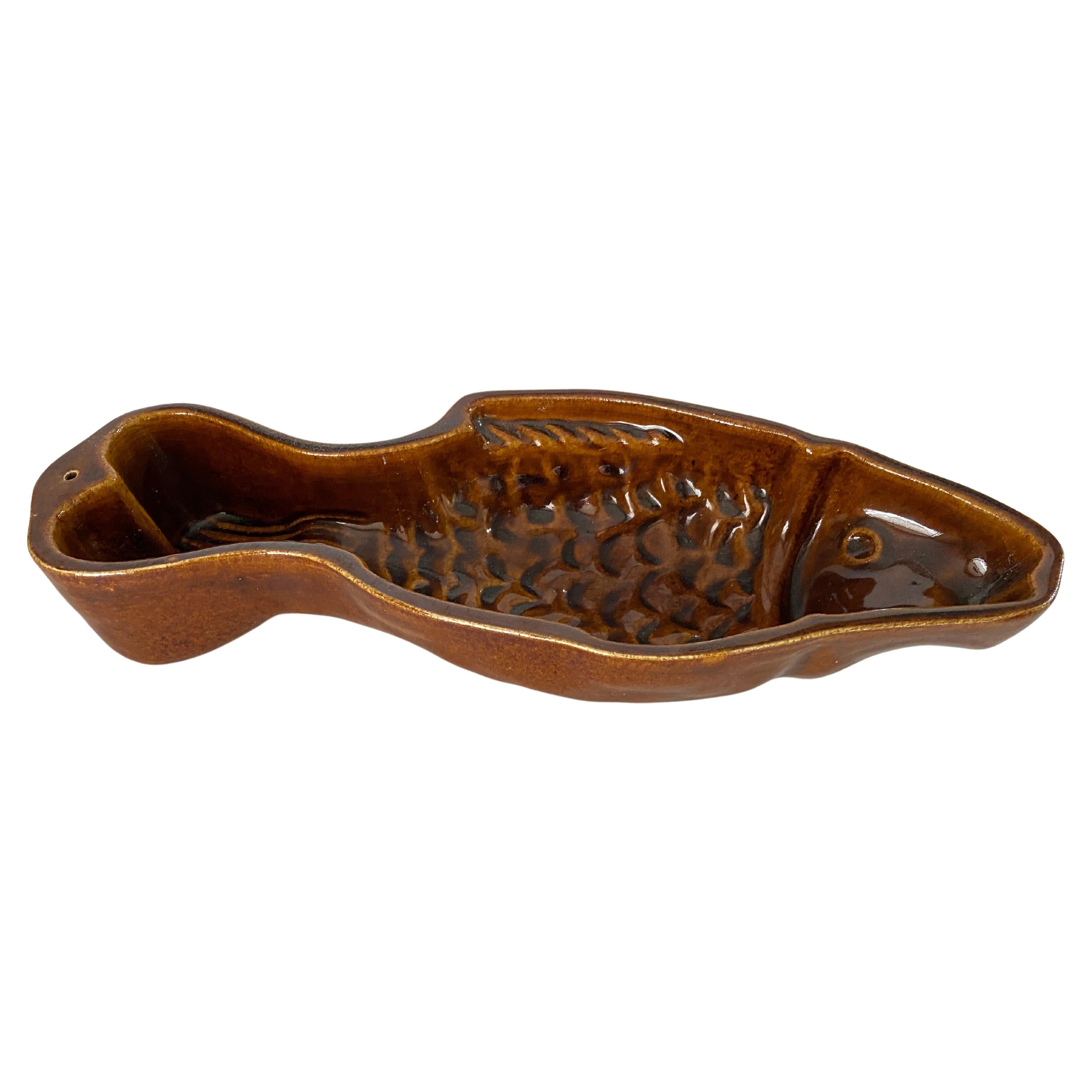 This Ceramic Ashtray or Vide Poche, has a Fish Shape. The colors are the Brown.
It has been made in Italy Circa 1960

