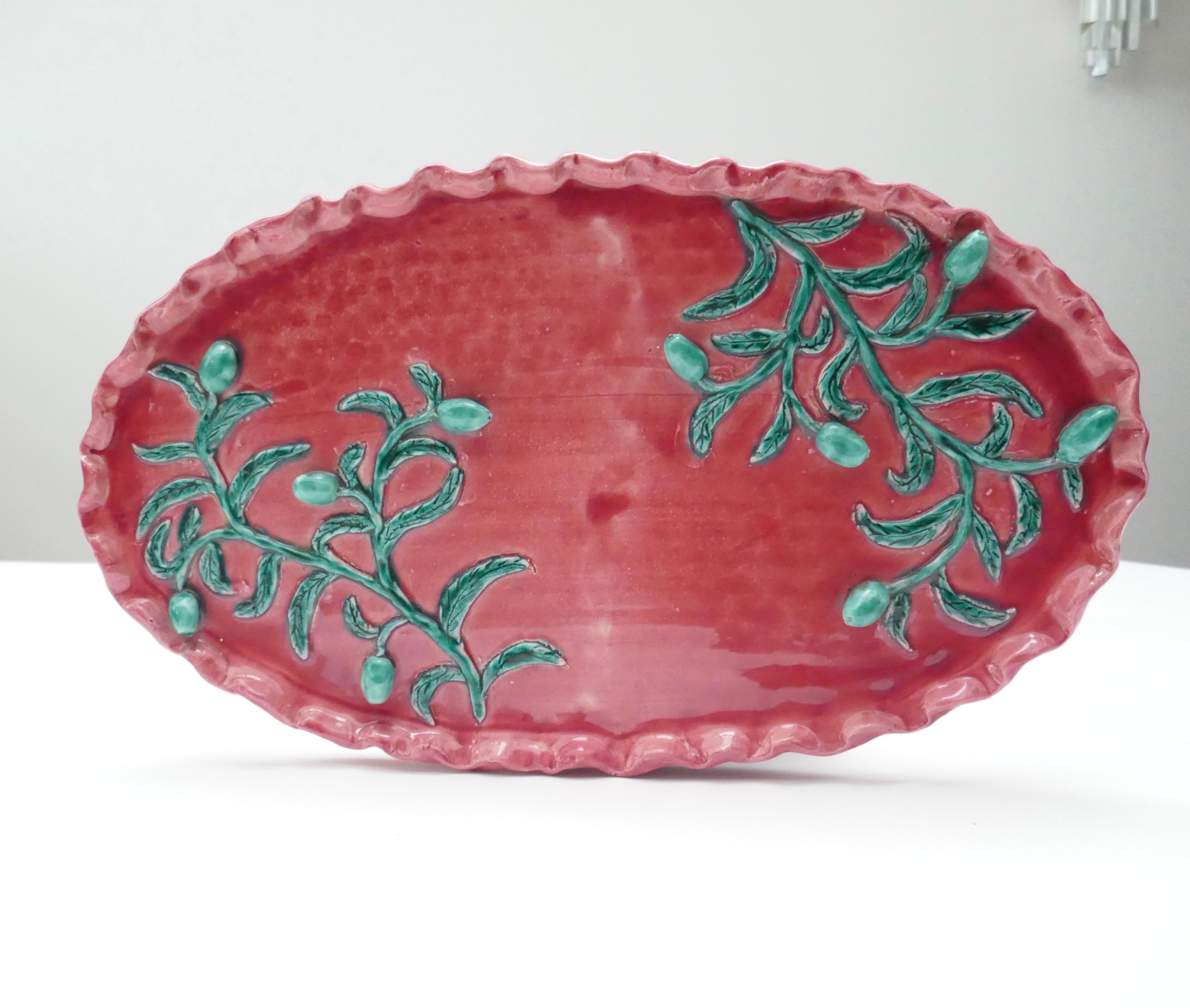 Large pottery centrepiece glazed in glossy red/raspberry enamel with raised glossy green enamel olives branches .

Signed Jerome Massier creation Paule Ville. Unique piece.

Designers of Mediterranean decorative ceramics, the Massiers were great
