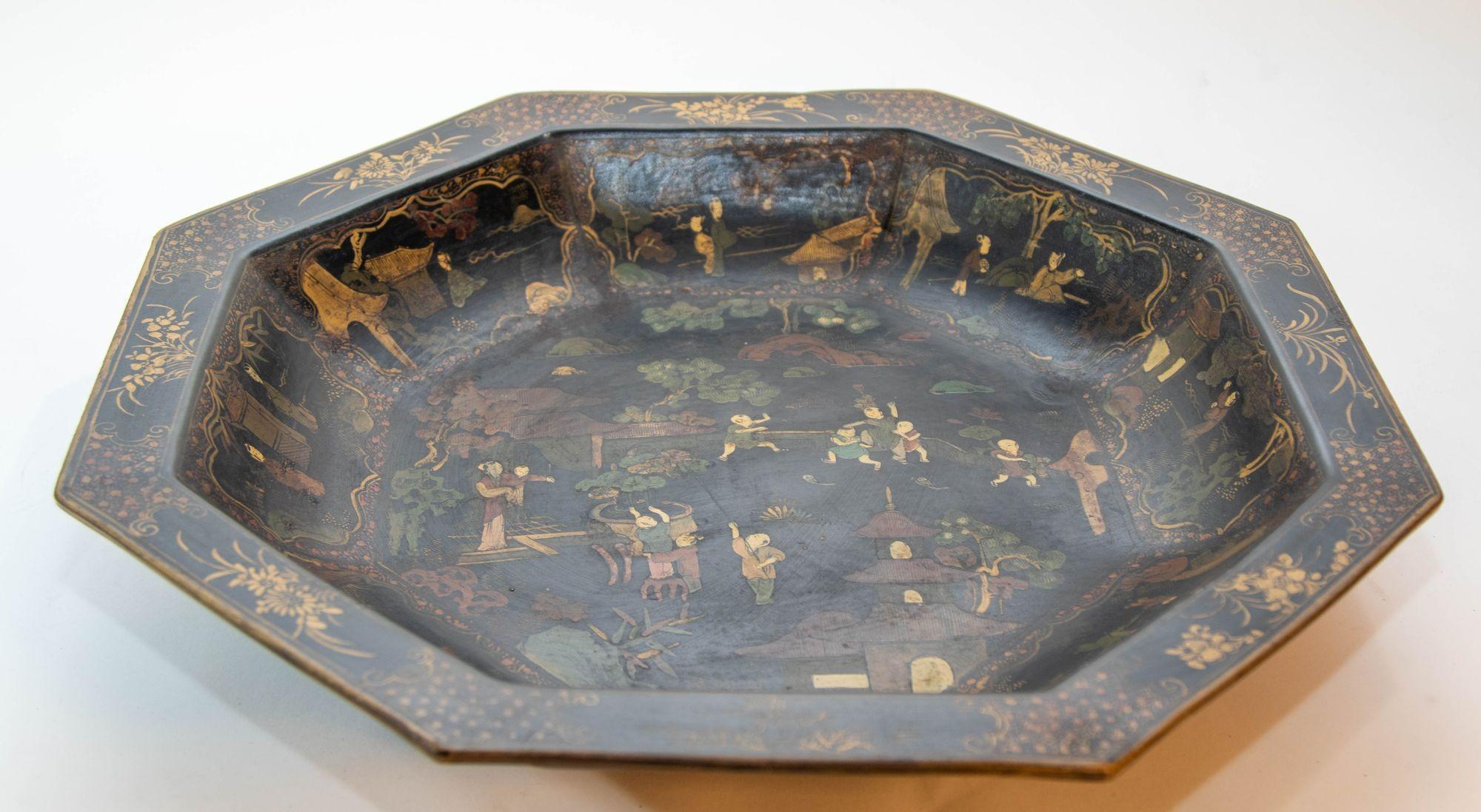 Large Ceramic Chinese Platter in Black Gilt Hand Painted 1940s.
Antique Chinoiserie black octagonal decorative ceramic platter with numerous figures and gilt detail.
Asian Chinese black ceramic and gilt hand painted tray, made for the export