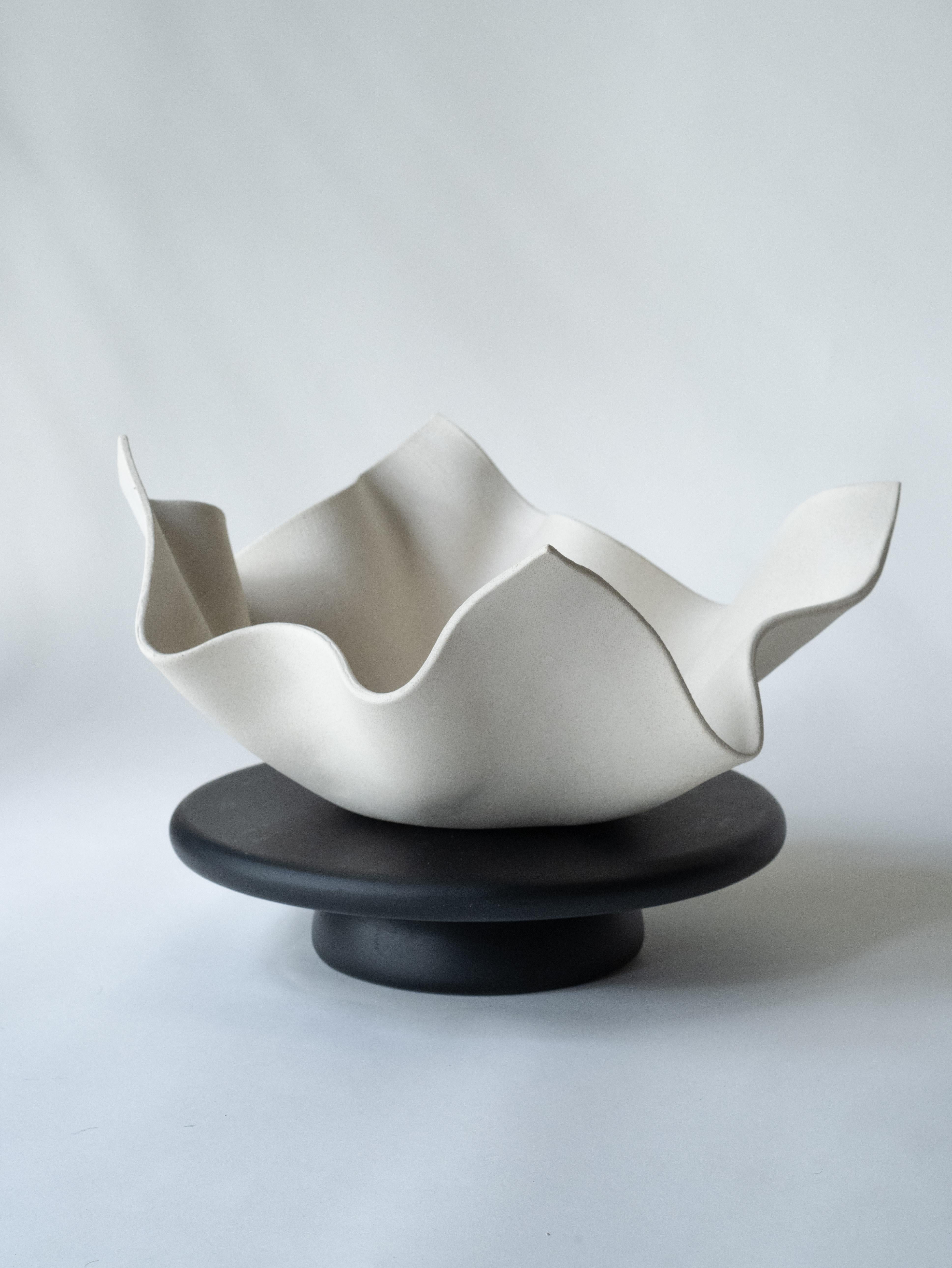 Exquisitely crafted, our windswept bowl is a testament to artisanal excellence. Meticulously handmade by skilled artisans in our studio, it emerges from pure white clay, resulting in a stunning aesthetic. Its versatility shines as it can serve as a