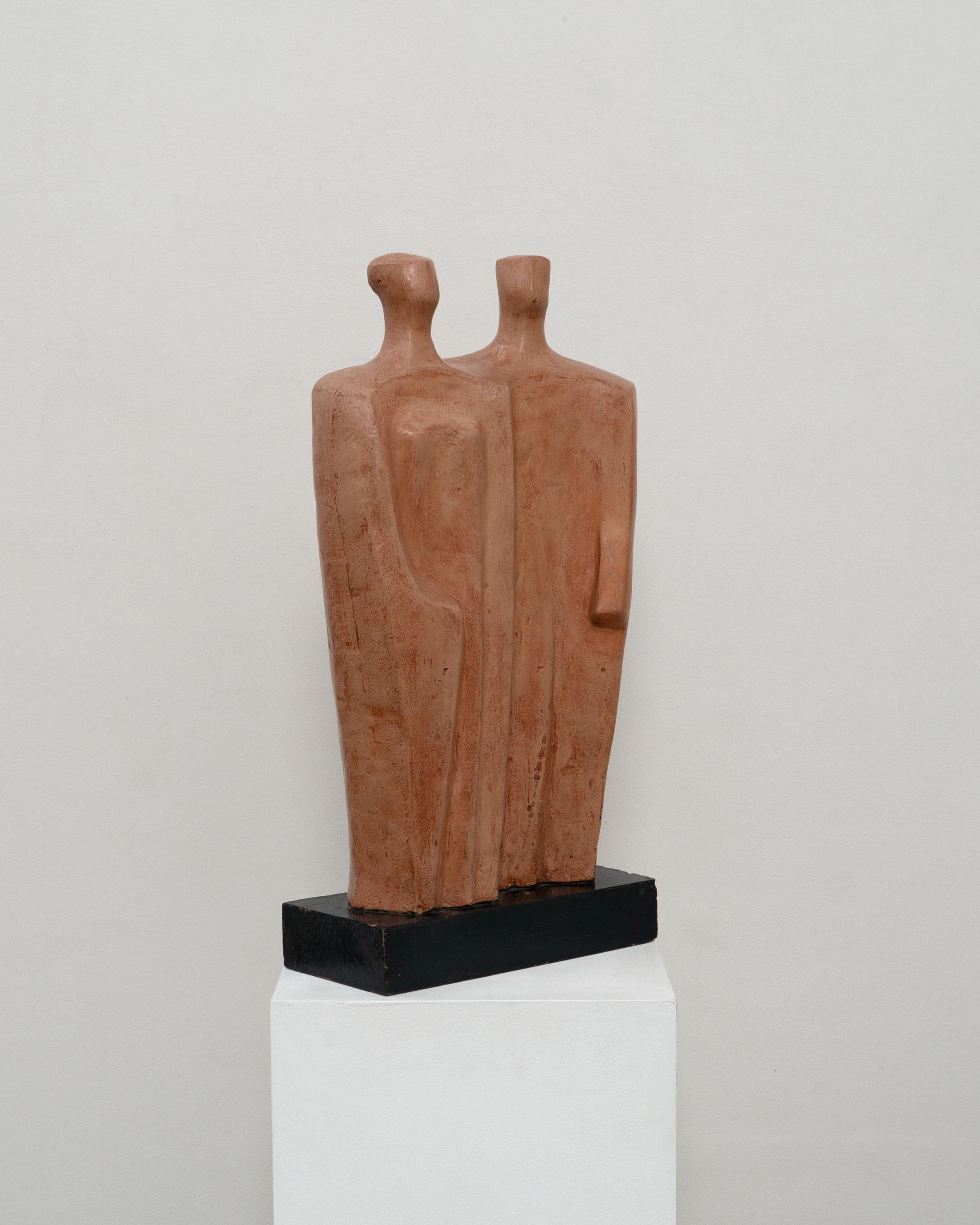 A large abstract sculpture depicting two standing figures by German artist Eugen Clermont (1904 - 1975). Made from ceramic and sitting on a lacquered wooden plinth. Signed on the reverse. 

Dimensions (cm, approx)
Height: 50
Width: 29
Depth: 12

In