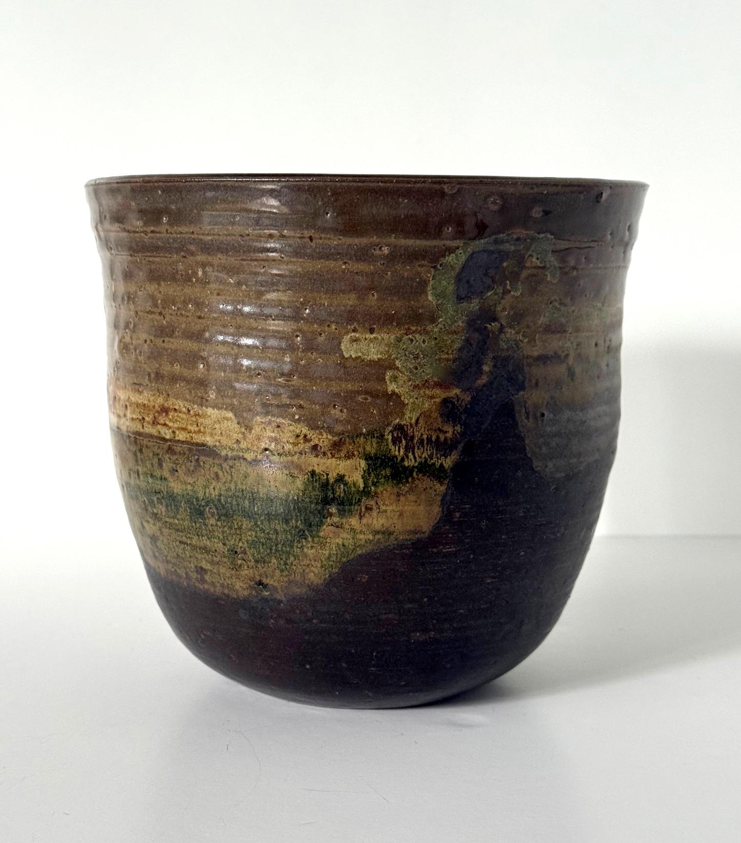 A large glazed ceramic vase circa 1978 made by Japanese American artist Toshiko Takaezu (American, 1922 - 2011). Toshiko's work was heavily influenced by the Japanese ceramic tradition, aesthetics and philosophy. 
The relatively large hand-built