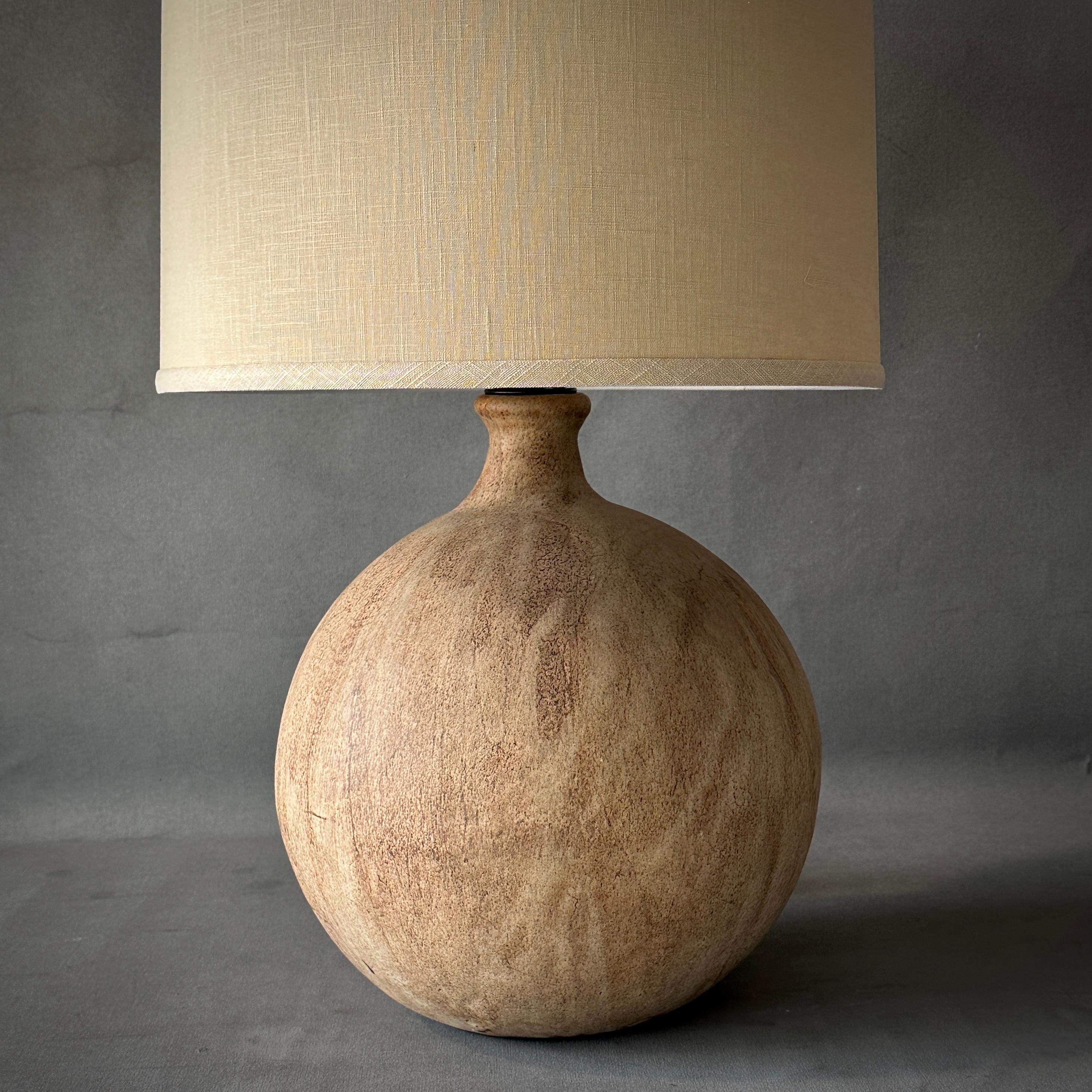 Belgian mid-century large spherical ceramic lamp with soft abstract patterning and pale terracotta finish. Includes ivory linen shade. A versatile table lamp with a cool neutral color palette.

Belgium, circa 1960

Dimensions: 16W x 16D x 26H