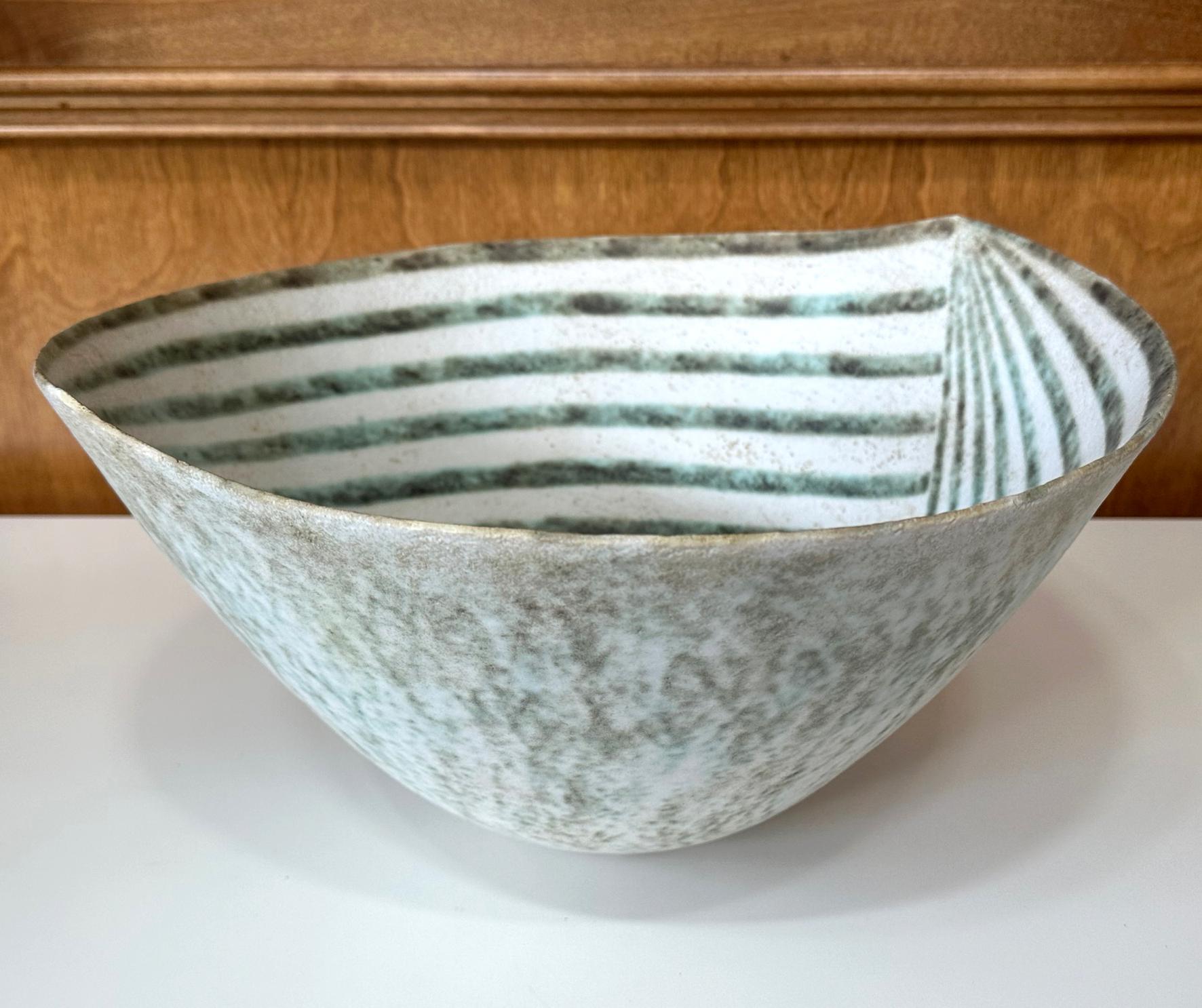A large stoneware glazed bowl in a rare leaf form by British studio potter John Ward (1938-2023) circa last quarter of the 20th century. The impressive, oversized bowl features a distinct leaf-shape along the contour of the opening. The interior
