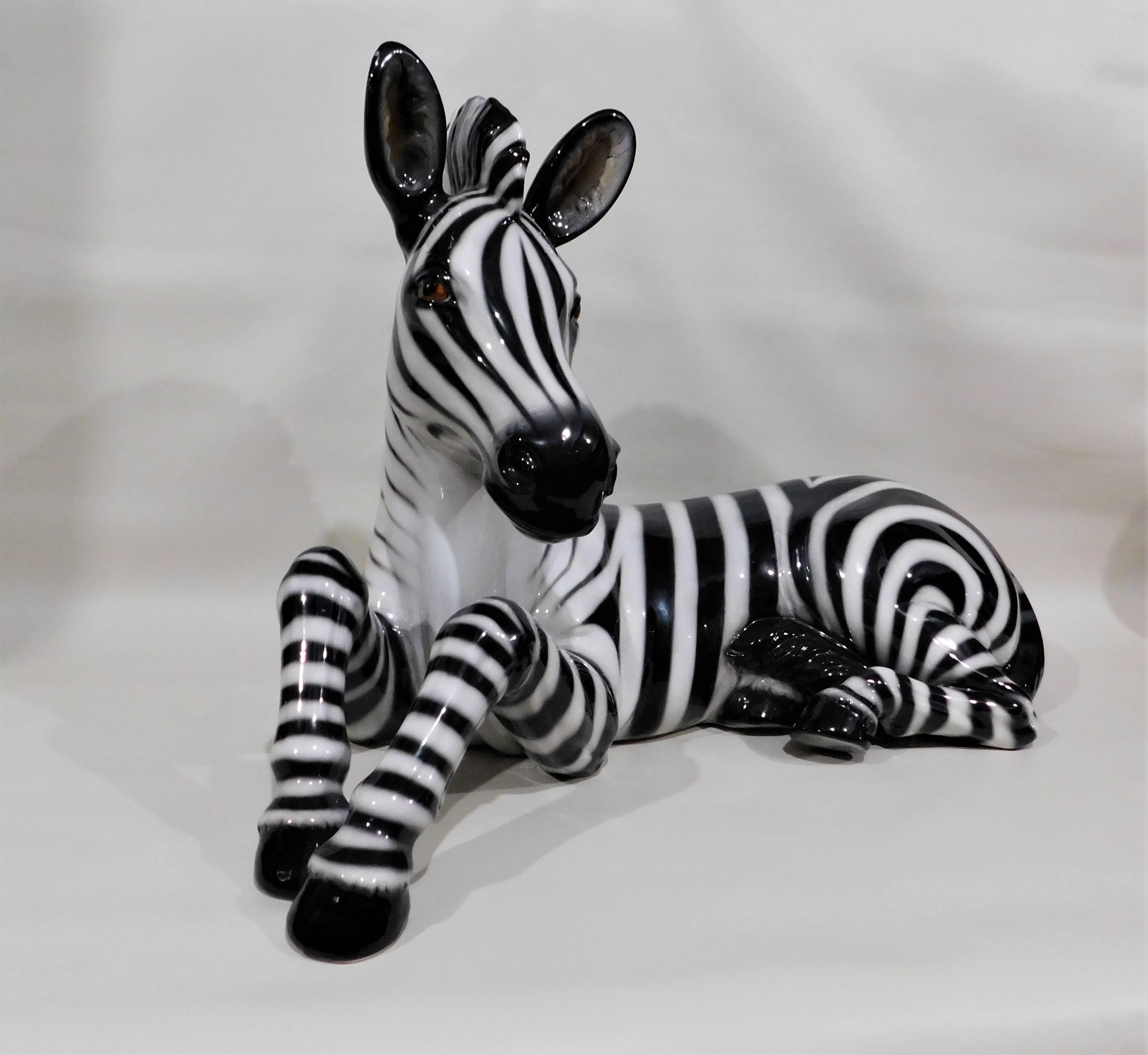 Circa 1960 handmade, painted and glazed in Italy, large mid-century modern ceramic zebra. This rare charming sculpture presents an accurate and detailed depiction of an elegant zebra.  Over two feet wide and nineteen inches high.