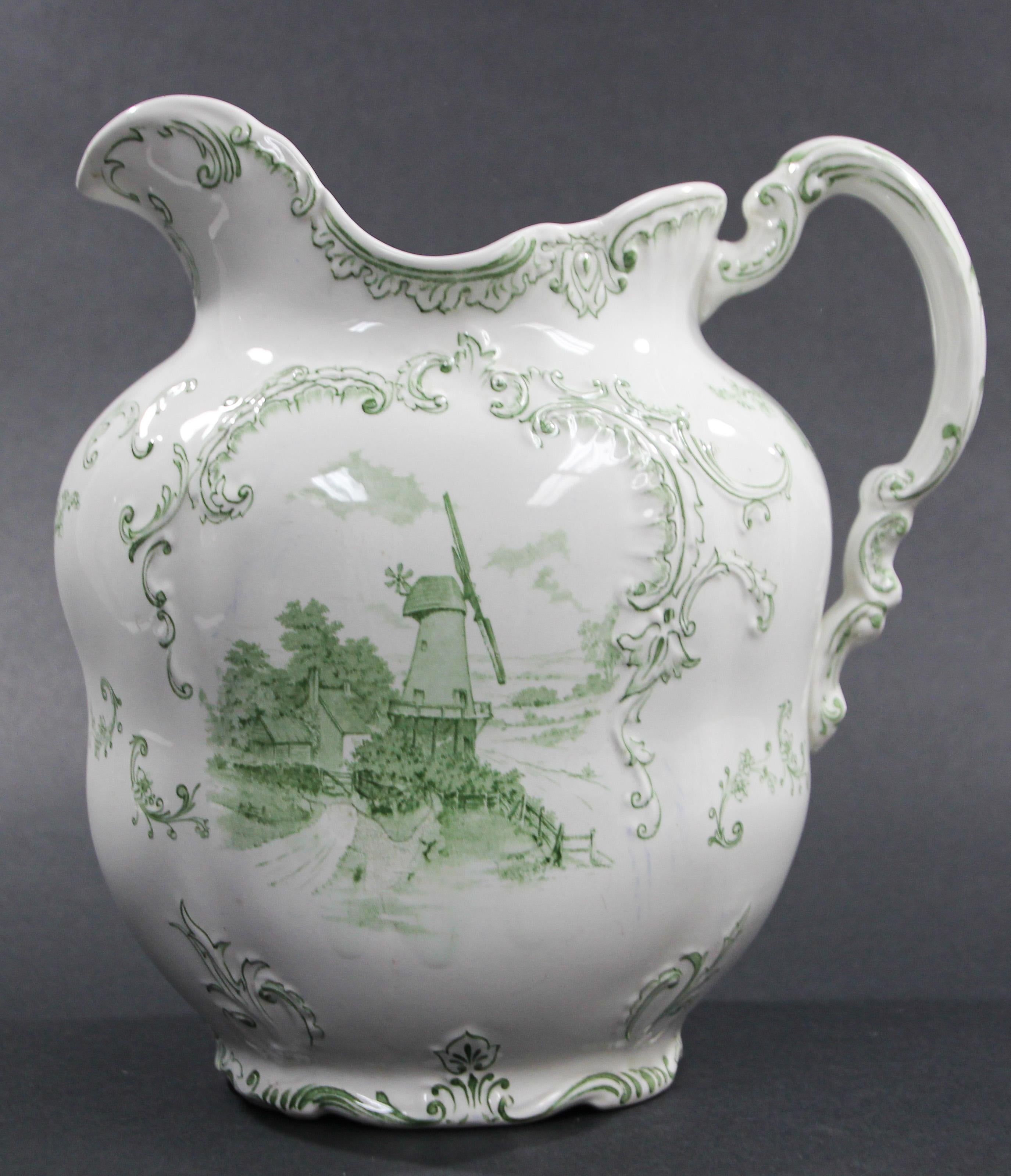 Stunning Delft green and white pitcher in very good condition.
This is a beautiful and hard to find large water pitcher.
The painting depicts a boat on one side and on the other side a country scene.
It is beautiful and really stands out in a