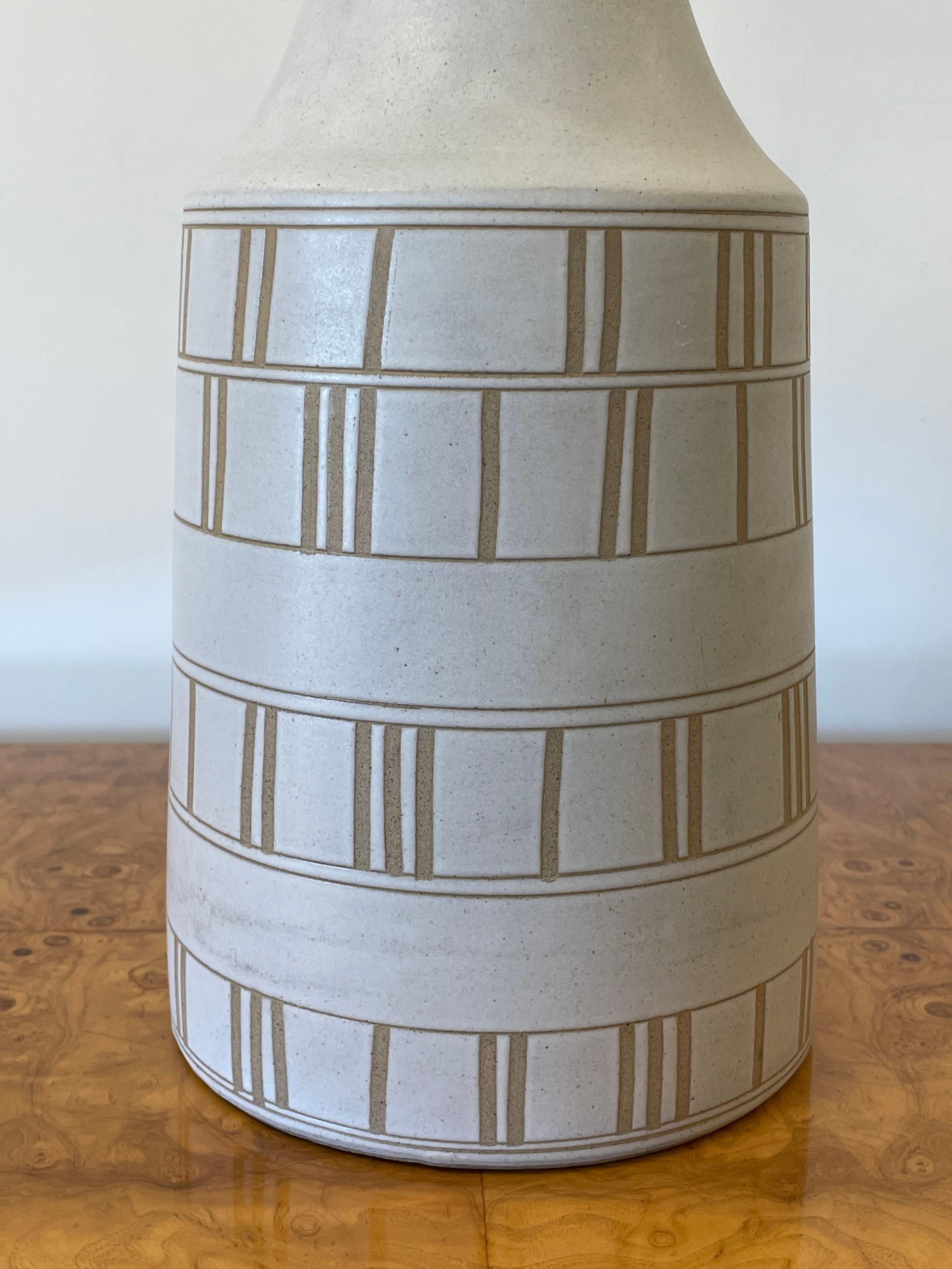 Large table lamp by famed ceramicist duo Jane and Gordon Martz for Marshall Studios. Great neutral color palette in off white and tan.

Overall
32.5” tall
17” wide 

Ceramic 
15.5” tall
7.5” wide.
 

Shade is shown for illustrative purposes only and