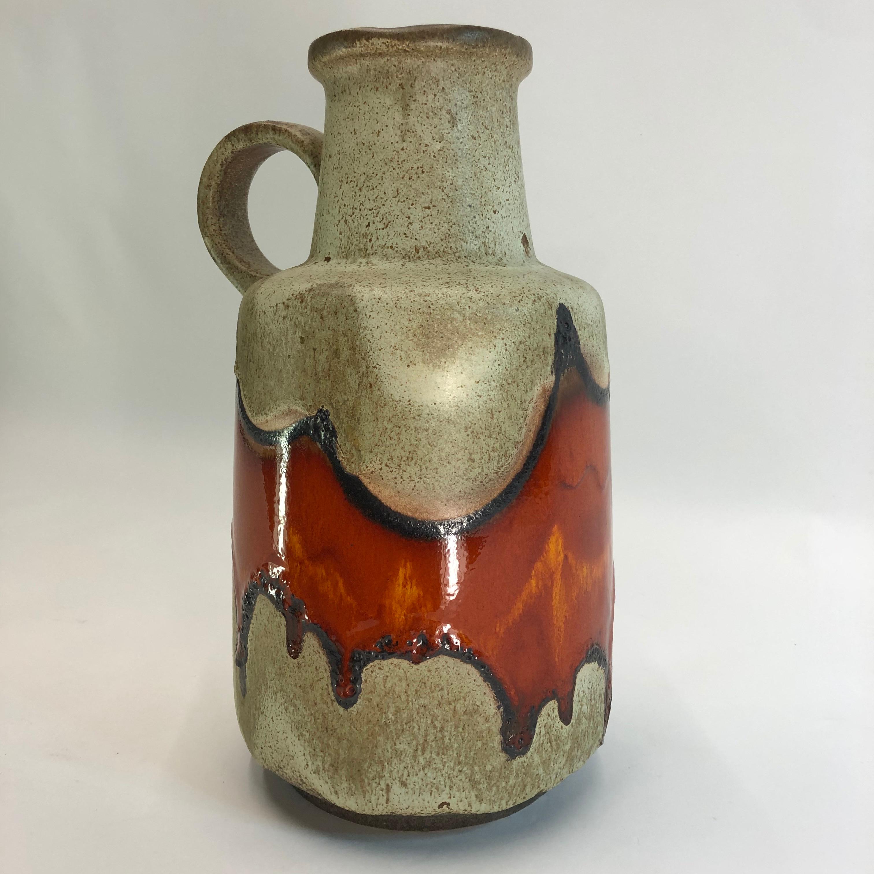 This vase has a beautiful orange fat lava pattern, Scheurich West-Germany, 1970. The inside is glazed. Very good condition. No chips or cracks.
Maker Scheurich. Measure: 40cm.

 