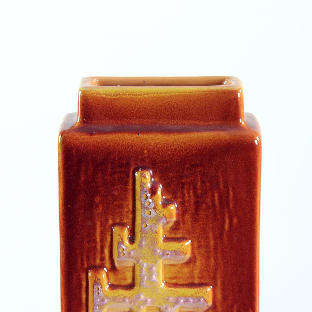 Beautiful midcentury vase produced in Czechoslovakia in 1960s. The vase was produced by ZST Pezinok. It is made of ceramic clay, glazed finish. The vase has a unique rectangular shape of the base and it is finished with sculptural design on each