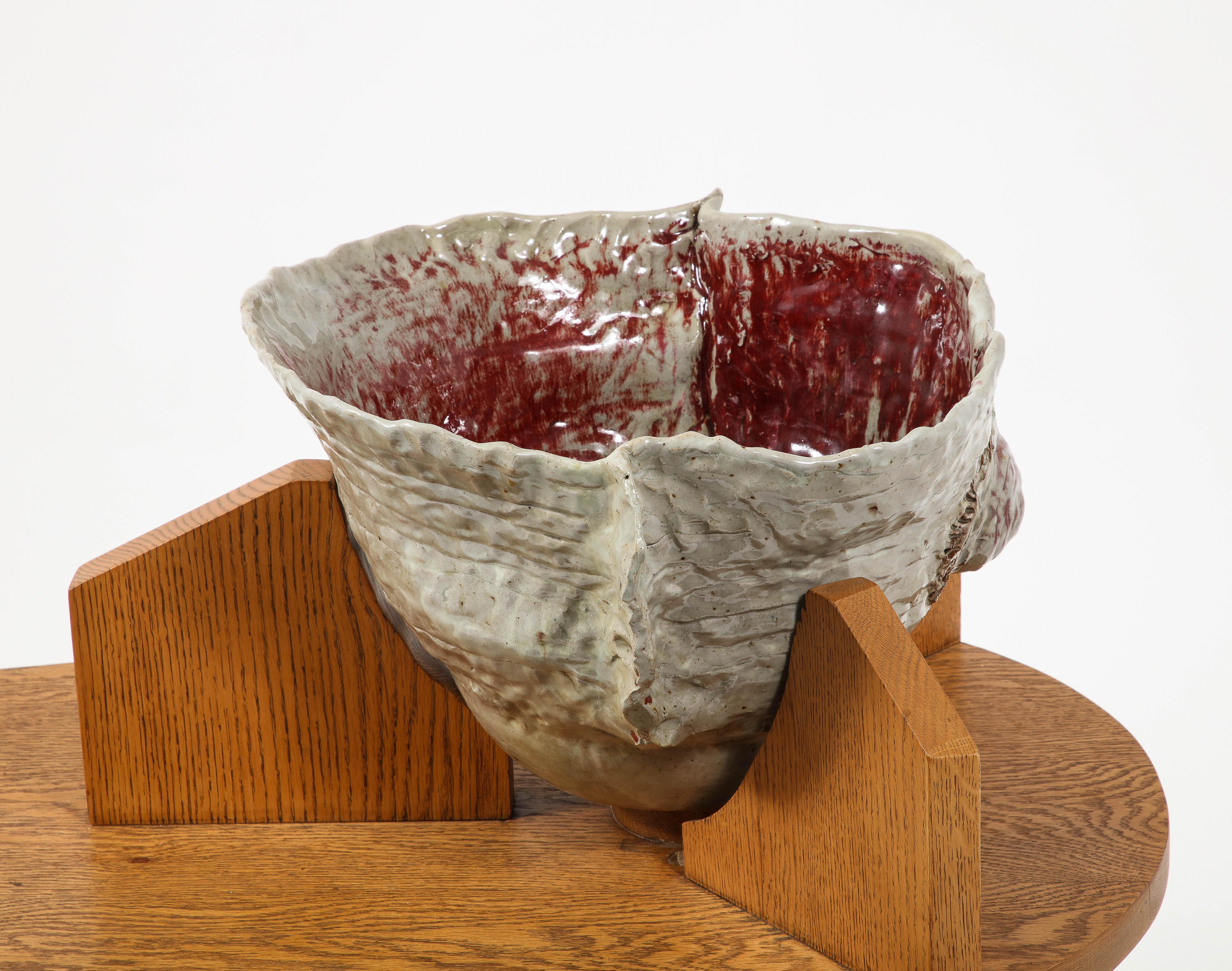 A large ceramic free-throw vessel on a solid oak base in the Usonian style.
