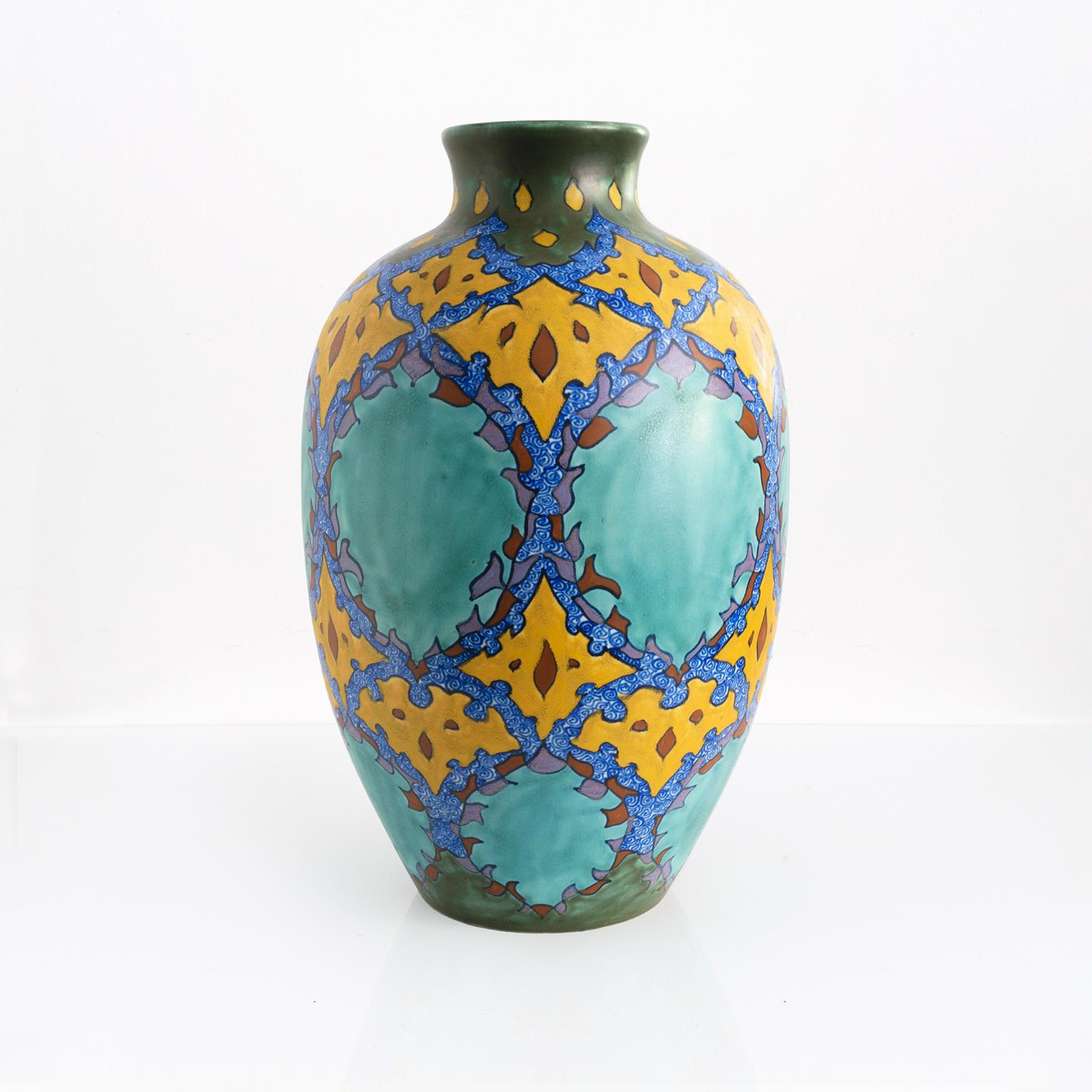 A large, brilliantly decorated ceramic vase for early 20th century. Signed on the bottom “Virginia”, made in Gouda, Holland. 

Measures: height: 17.75” diameter: 11”.