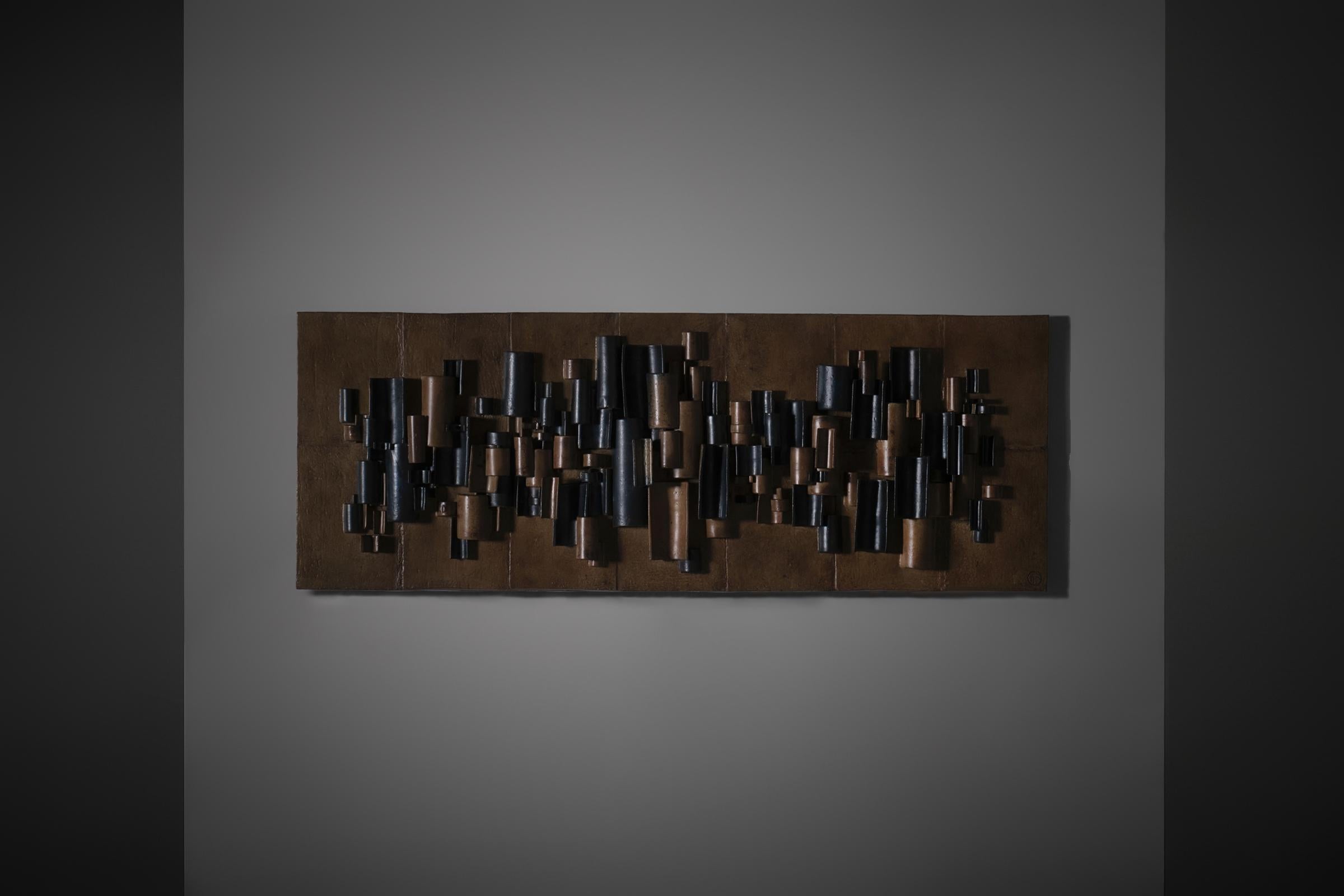 Large ceramic wall relief, 1970s. The panel shows a harmonious and rhythmic composition of cylindrical elements in different colors. The panel is composed of several large tiles fixed together and is mounted on a sturdy and strong wooden panel which