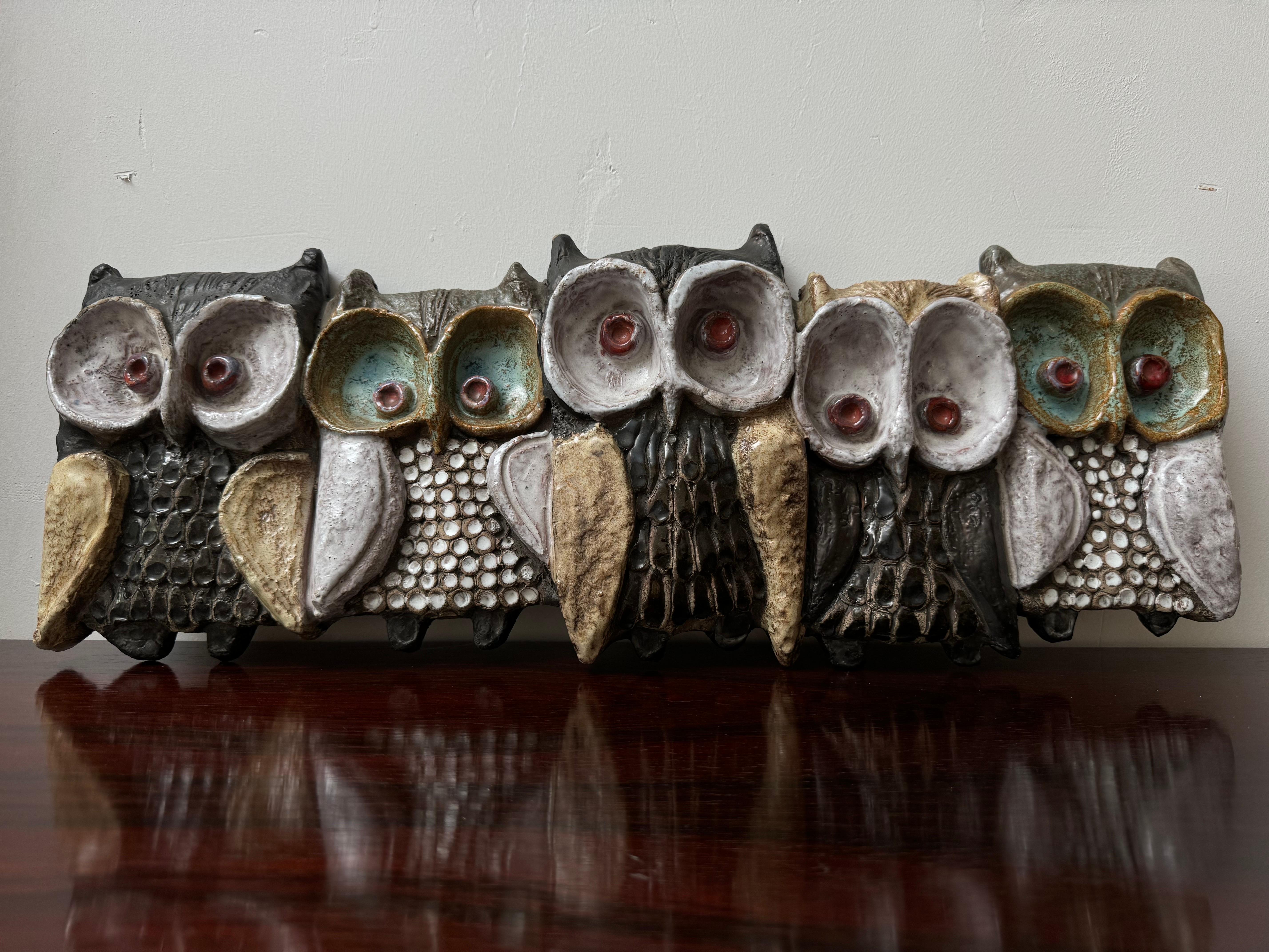 The dramatique of this family owl sitting on a branch is a beautiful piece of wall sculpture with each owl its own glazed color scheme. Unique hand-formed ceramic owl sculpture by Elisabeth Vandeweghe for Perignem, Belgium. In very good condition.