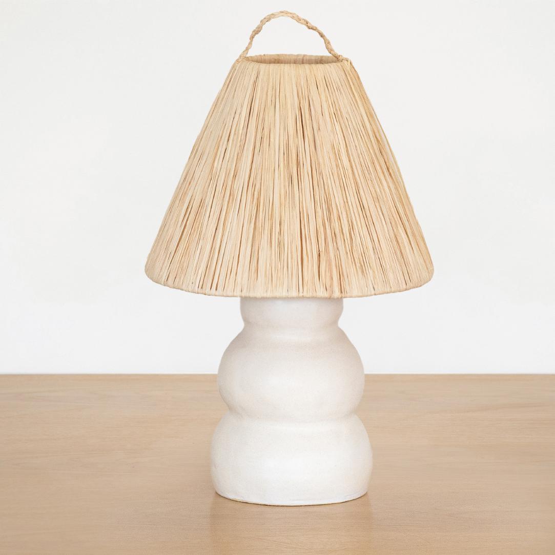 Newly made ceramic lamp in a wavy column-form handmade from terracotta and white glaze. New natural raffia shade, brass stem neck, and new white cloth cord wiring with switch. Modern organic form with a nice mix of materials. handmade in Spain.