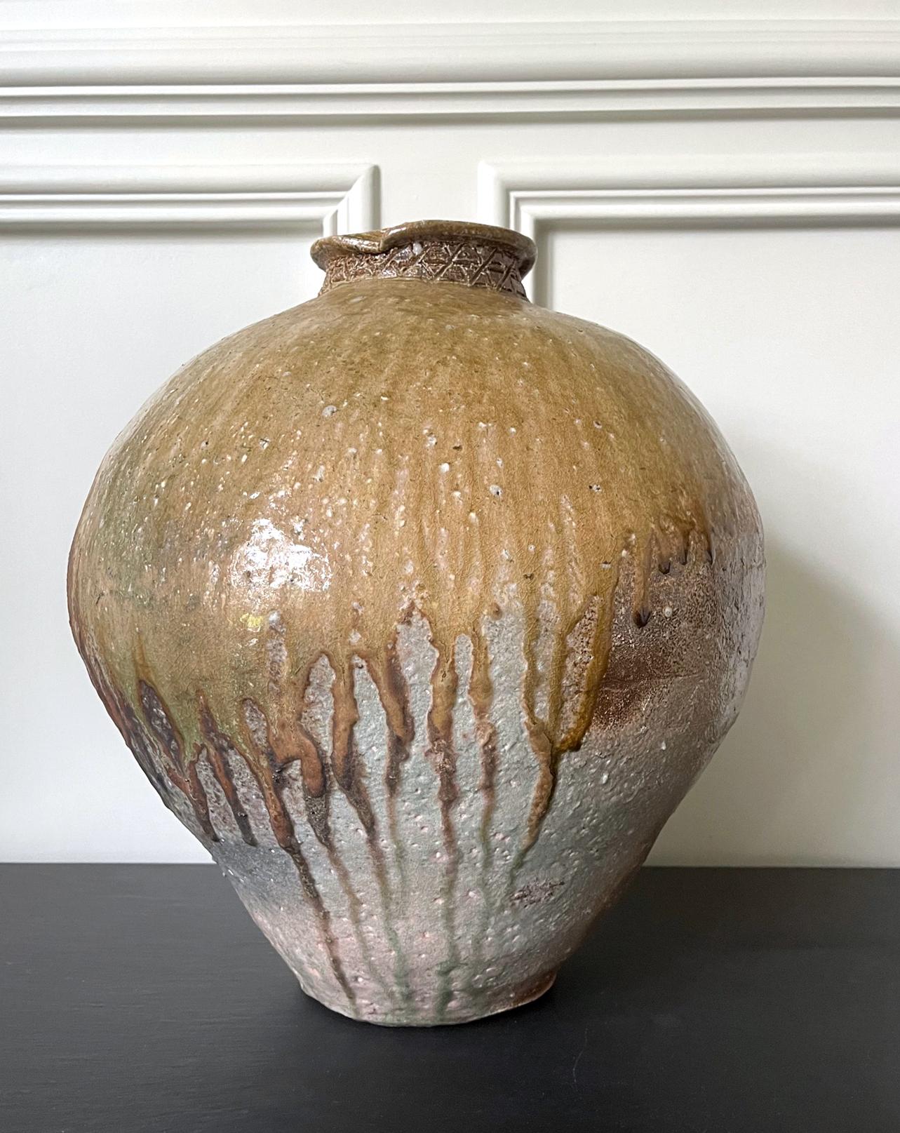 An impressive Shigaraki Tsubo (jar normally for storage) in an archaic form with a bulbous and robust body that opens with a small lipped mouth. Heavily potted with substantial size and volume, this tsubo showcases an exquisite surface with dripping