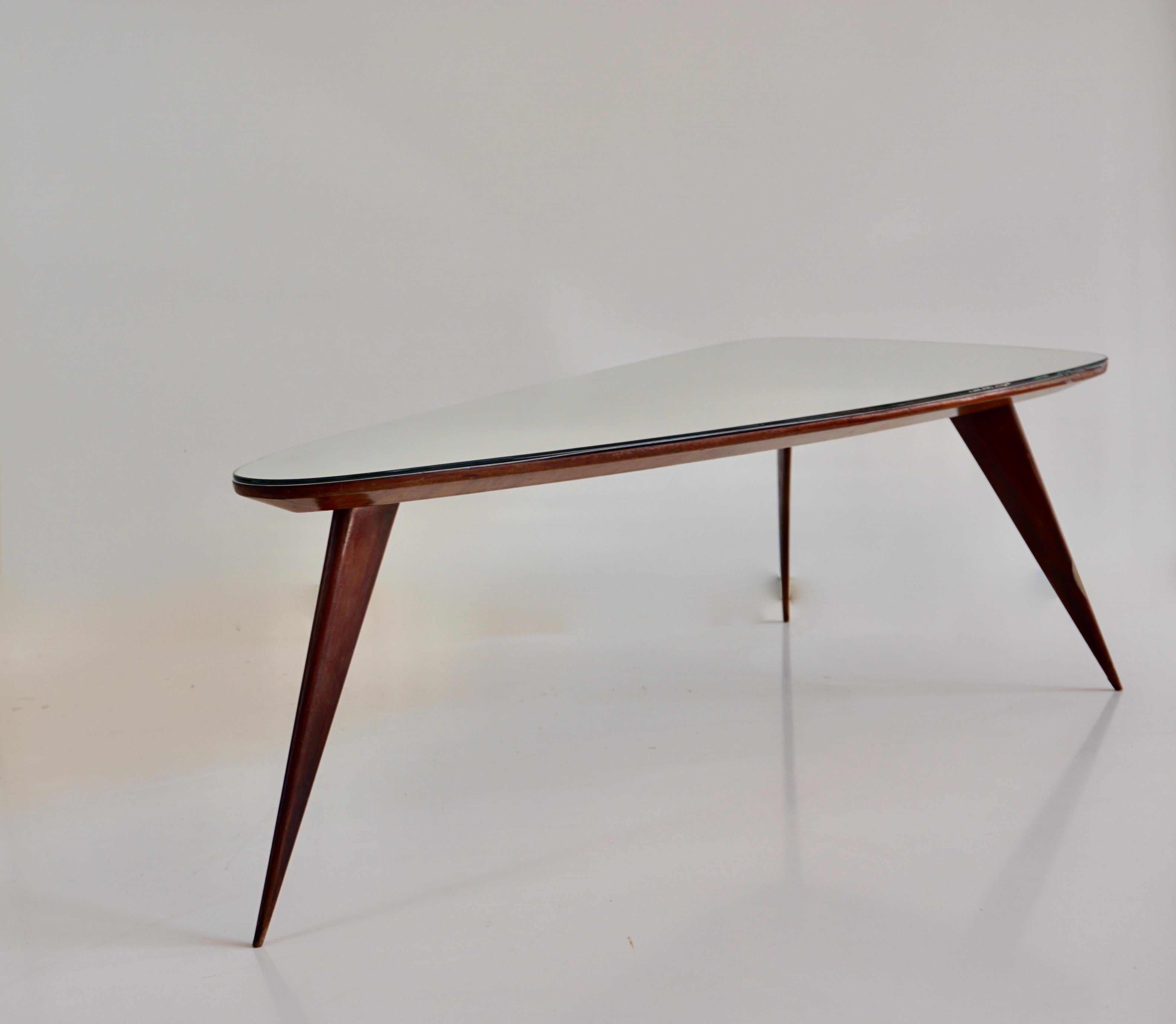 Italian large Cesare Lacca walnut coffee table, three feet irregular shape, mirrored top For Sale