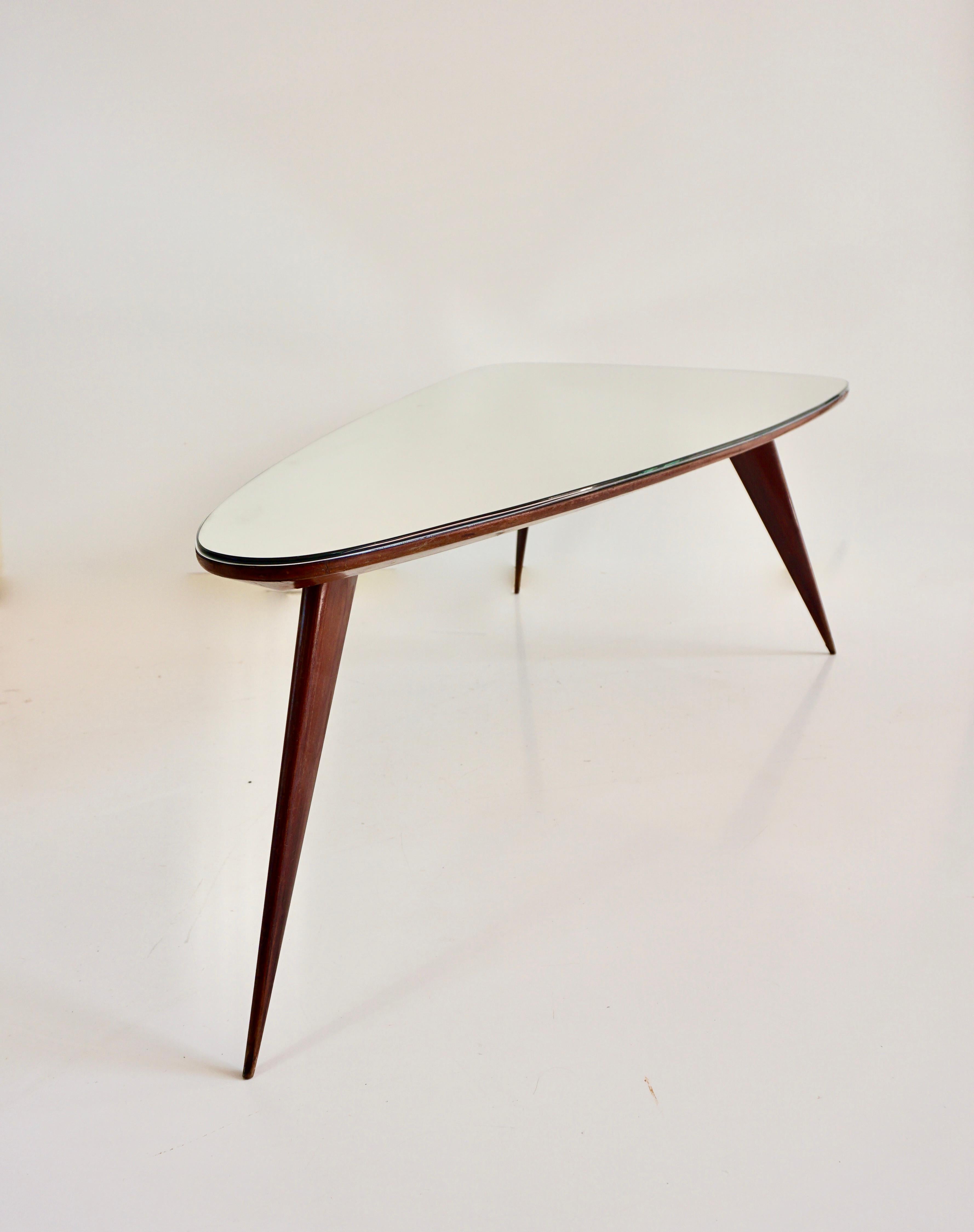 Mid-20th Century large Cesare Lacca walnut coffee table, three feet irregular shape, mirrored top For Sale