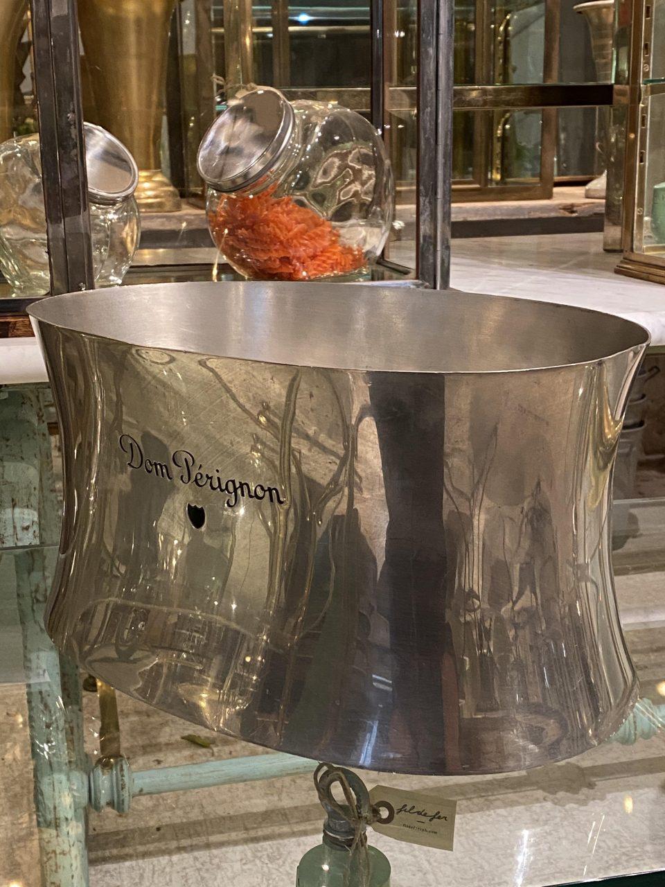 Handsome midcentury French champagne cooler/wine bucket, in a super beautiful oval shape with concave sides. Quality polished tin and has a nice name features on the side from Dom Pérignon.

Dom Pérignon is a famous and exclusive champagne brand