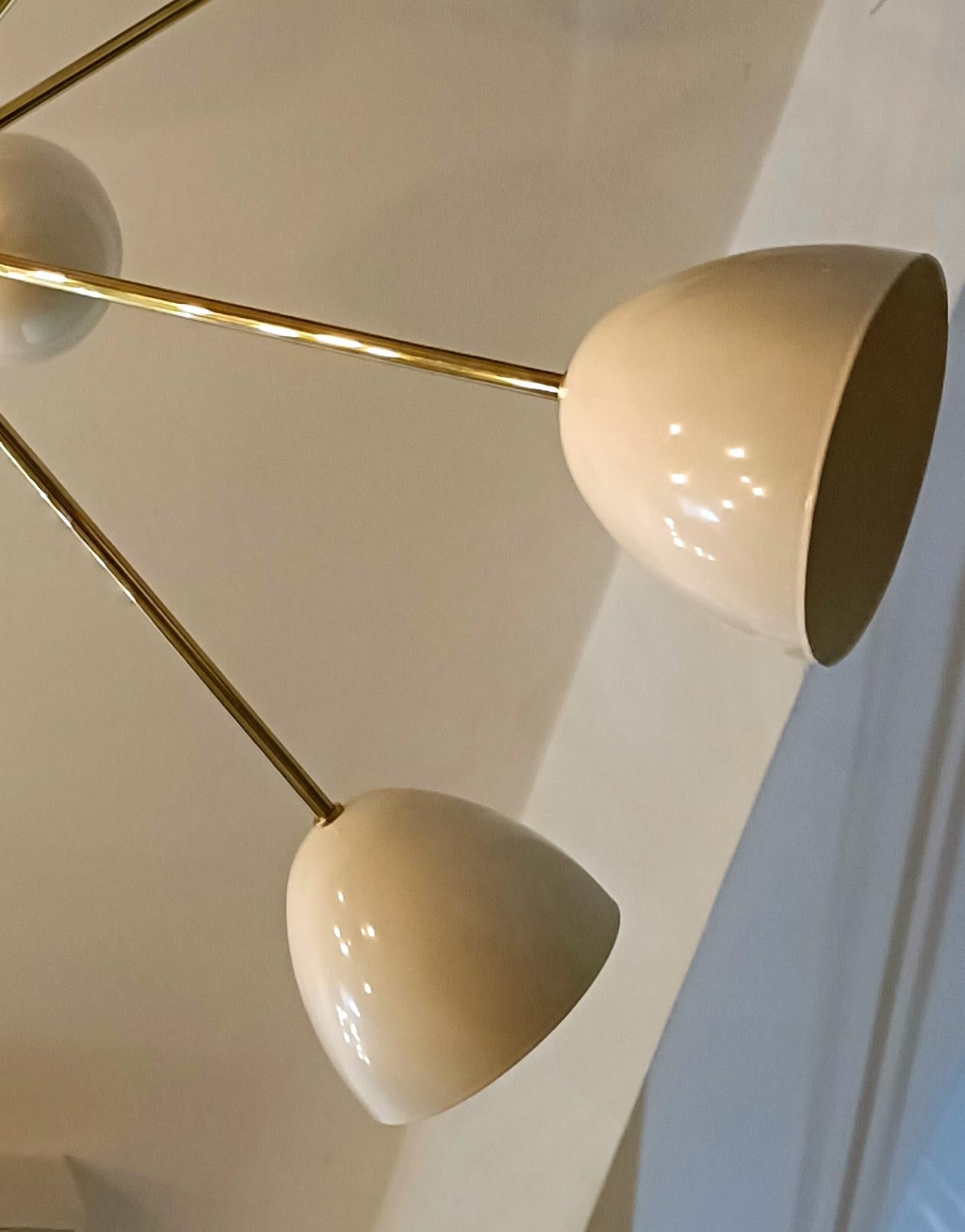 Solid brass and steel chandelier, Stilnovo style.
Finish - high gloss polished brass and RAL 9001 (gloss, ecru beige))

Diamater: 75 cm (30
