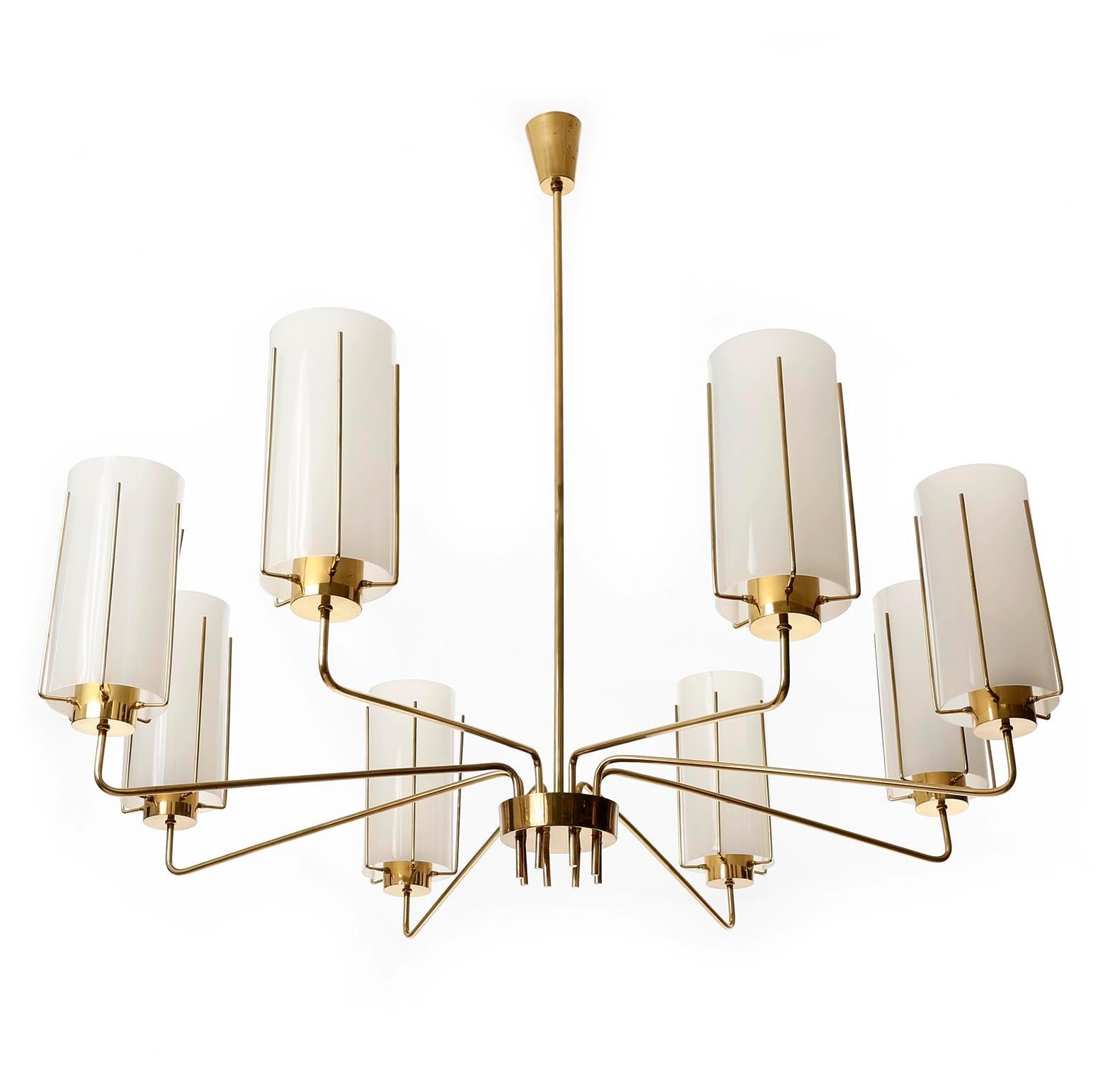 An extra large 8-arm chandelier manufactured in midcentury, crica 1960.
The light is made of a solid and polished brass frame with curved arms.
Each arm has one socket for a medium or standard screw base bulb covered by an acrylic opal glass lamp