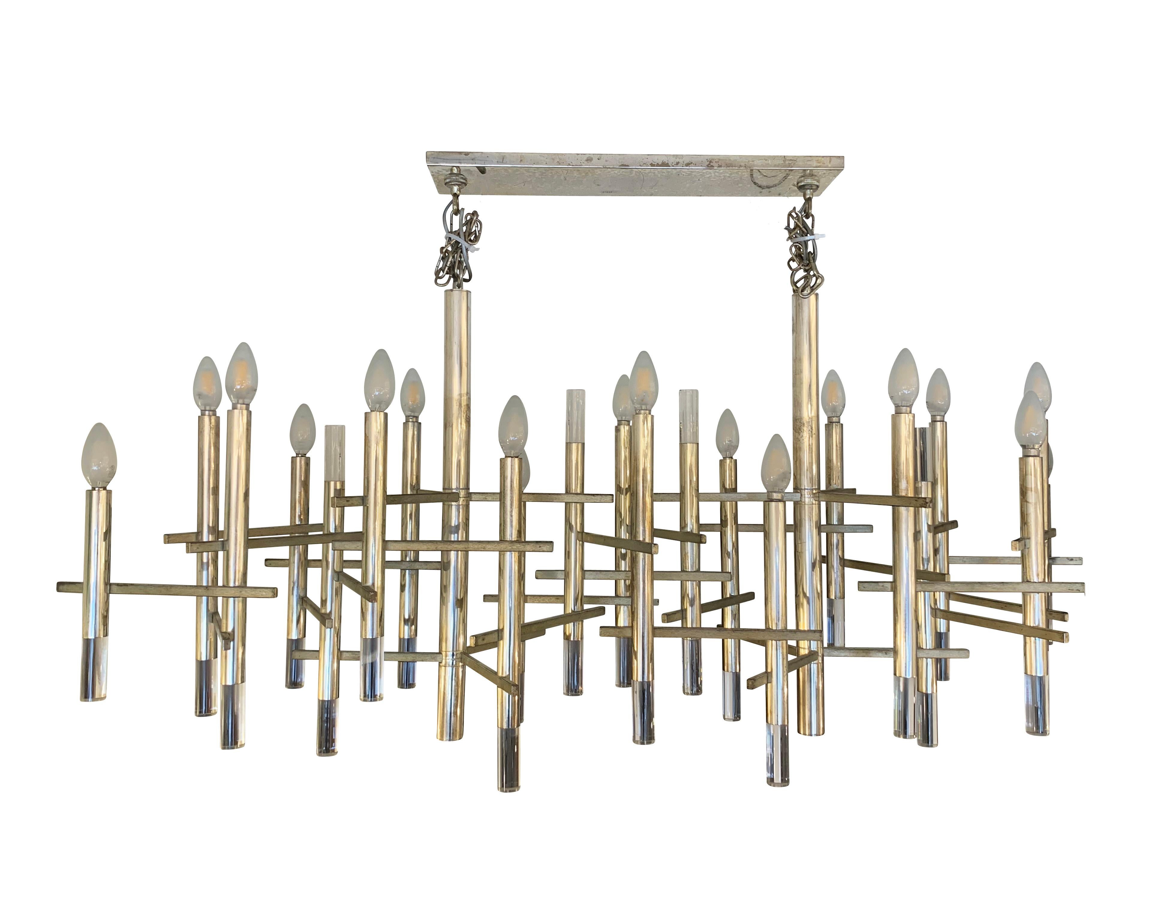 Large nickel chandelier with acrylic accents designed by Gaetano Sciolari in the 1960s after he visited New York and remained in owe of its skyscrapers. Holds 18 candelabra sockets and hangs from a rectangular canopy with two chains.

Condition: