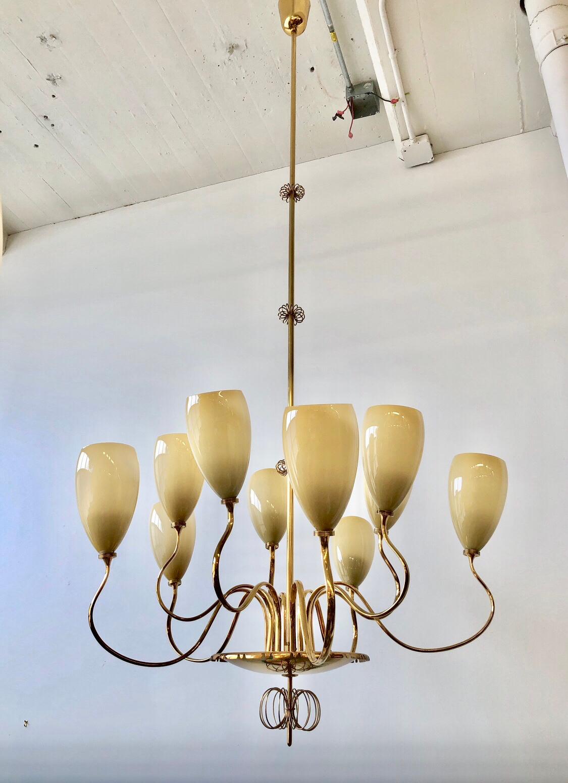 Large, 10 Lights Chandelier designed by Paavo Tynell for Idman Oy, Finland, circa 1950th.
Polished brass with opaline glass shades. Similar example is featured at Idman Oy Catalogue.
Diameter 32? , Height 70? ( can be adjusted).
Two Chandeliers