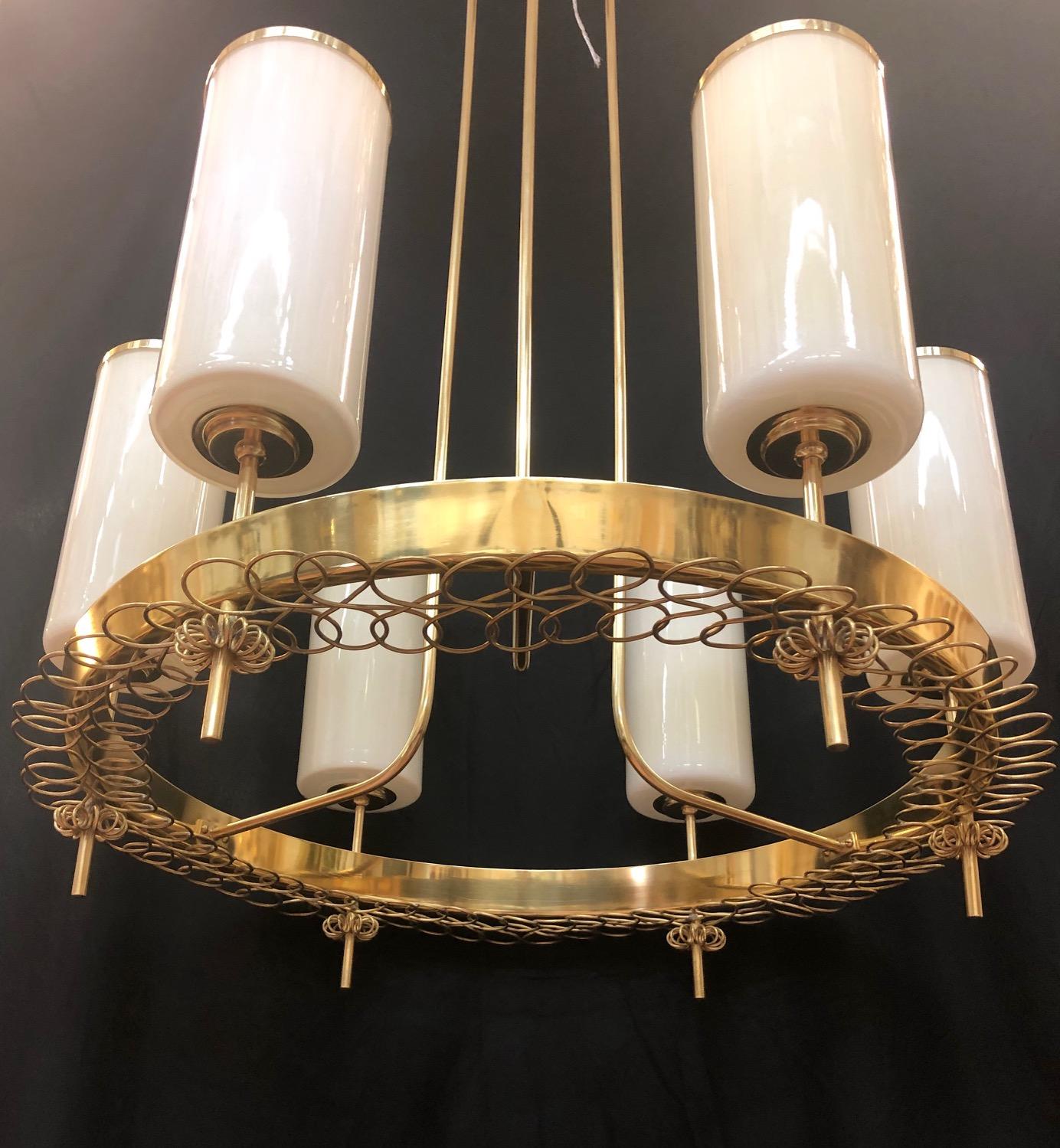 Large chandelier designed by Paavo Tynell for Taito Oy. Finland, circa 1940s.
Hand blown opaline glass shades with polished brass hardware.
Newly rewired.