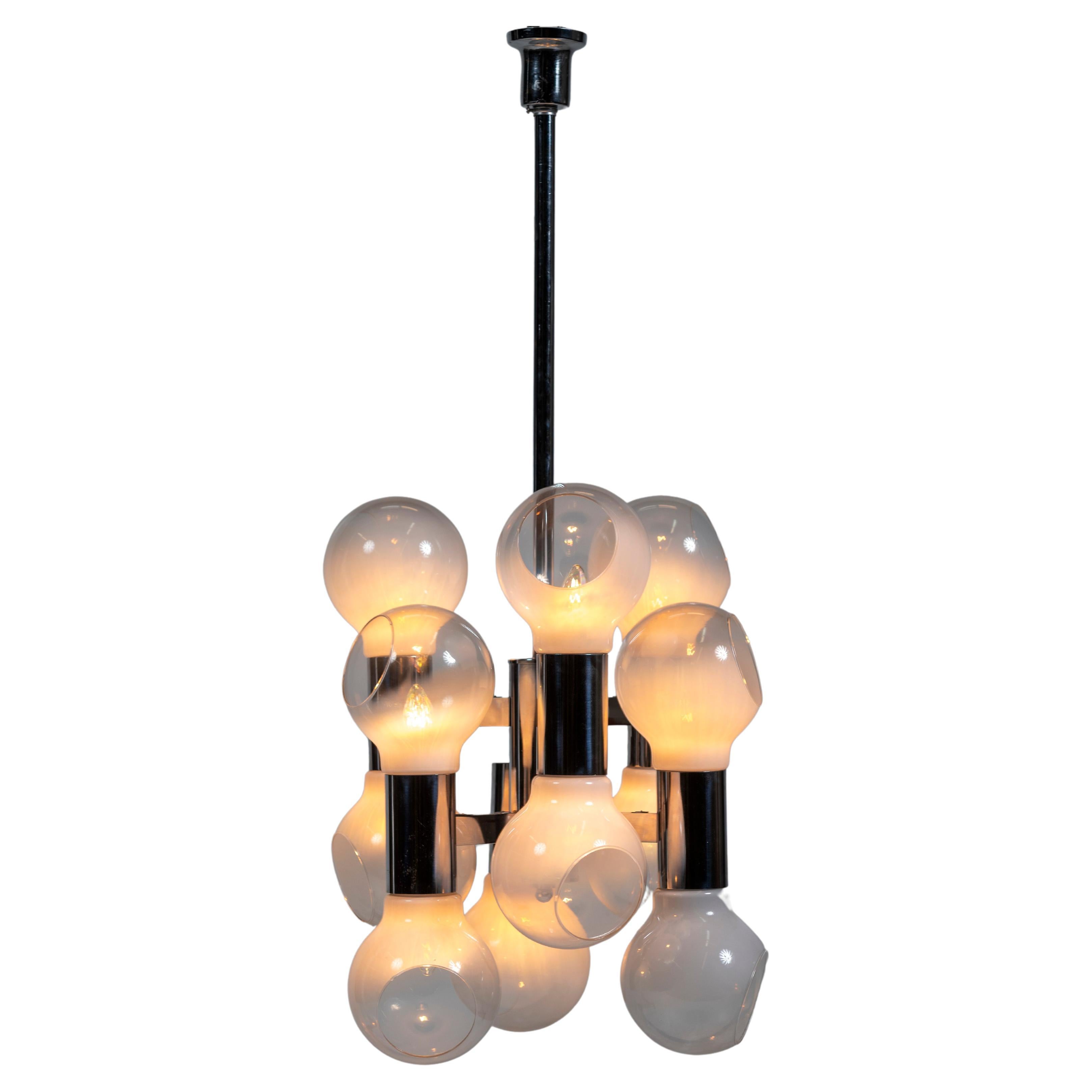 Reggiani has been recognized as a leader in modern lighting design since the mid 1950s. This vintage Italian statement chandelier has eight blown glass globes suspended from a chrome fixture. Timeless and bold, this piece creates an interesting glow