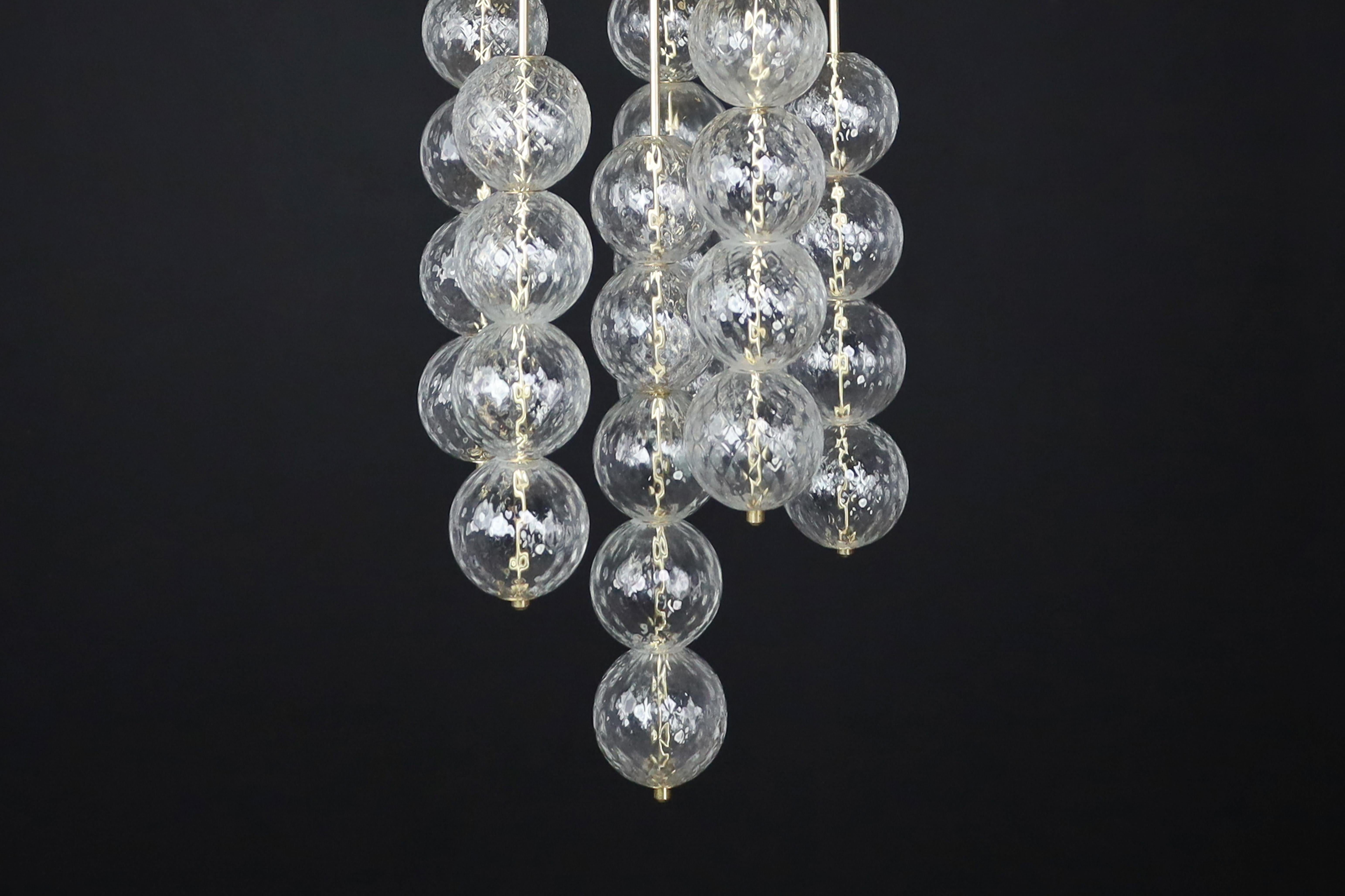 Large Chandelier with brass fixture and hand-blowed glass globes by Preciosa Cz. For Sale 4
