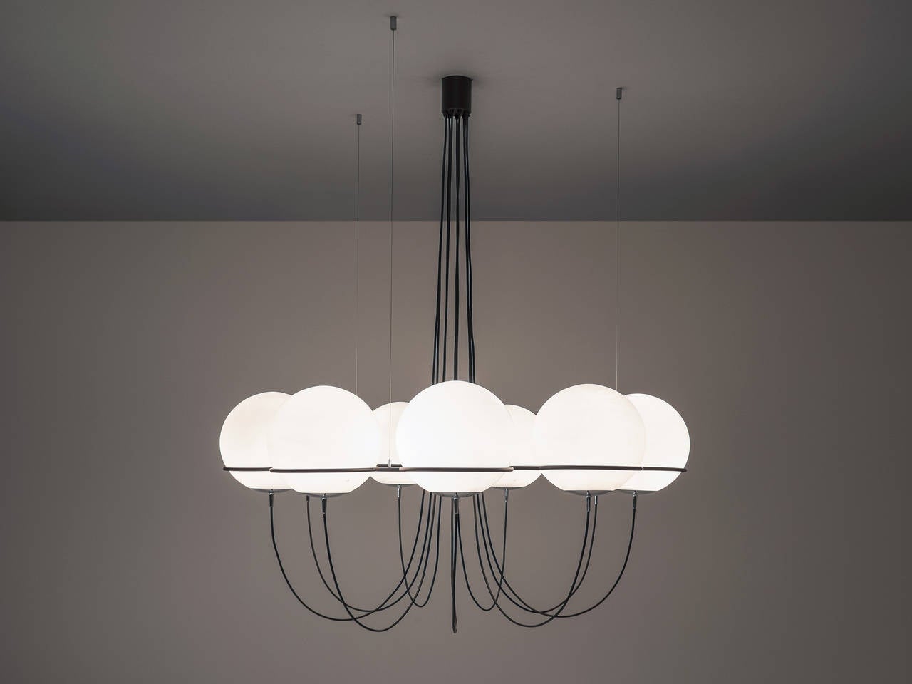 Chandelier, in metal and opal, Europe, 1970s.

Very large chandelier with nine opaline glass bulbs with chrome details. It is obvious that this design is inspired on the earlier designs of Gino Sarfatti for Arteluce, but this one is as well very