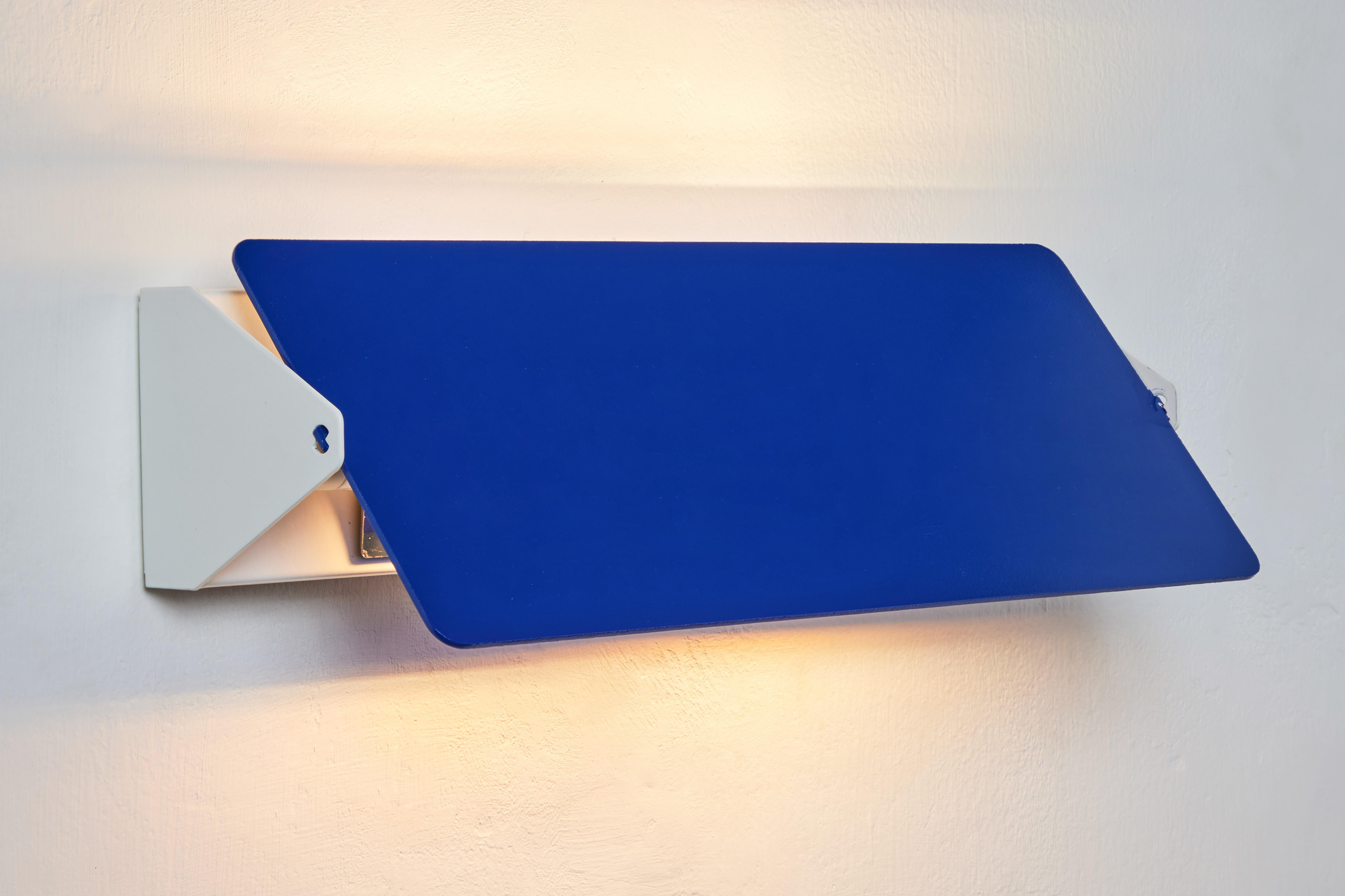 Large Charlotte Perriand 'Applique À Volet Pivotant Double' wall light in blue. 

Originally designed in the 1950s as the iconic CP1, these newly produced authorized re-editions are still made in France with the highest level of integrity and