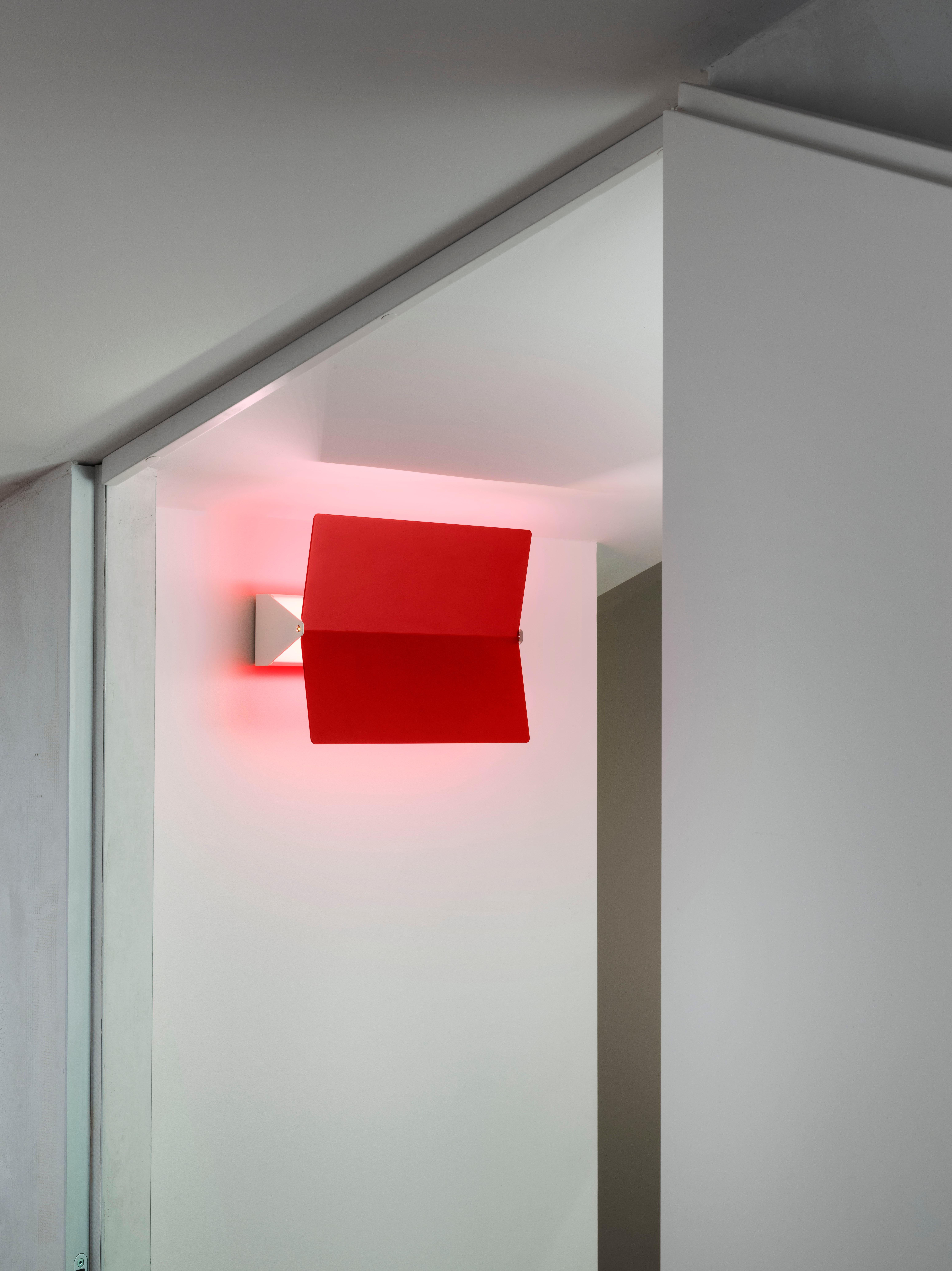 Large Charlotte Perriand 'Applique À Volet Pivotant Plié' wall light in red. 

Originally designed in the 1950s as the iconic CP1, these newly produced authorized re-editions are still made in France with the highest level of integrity and attention