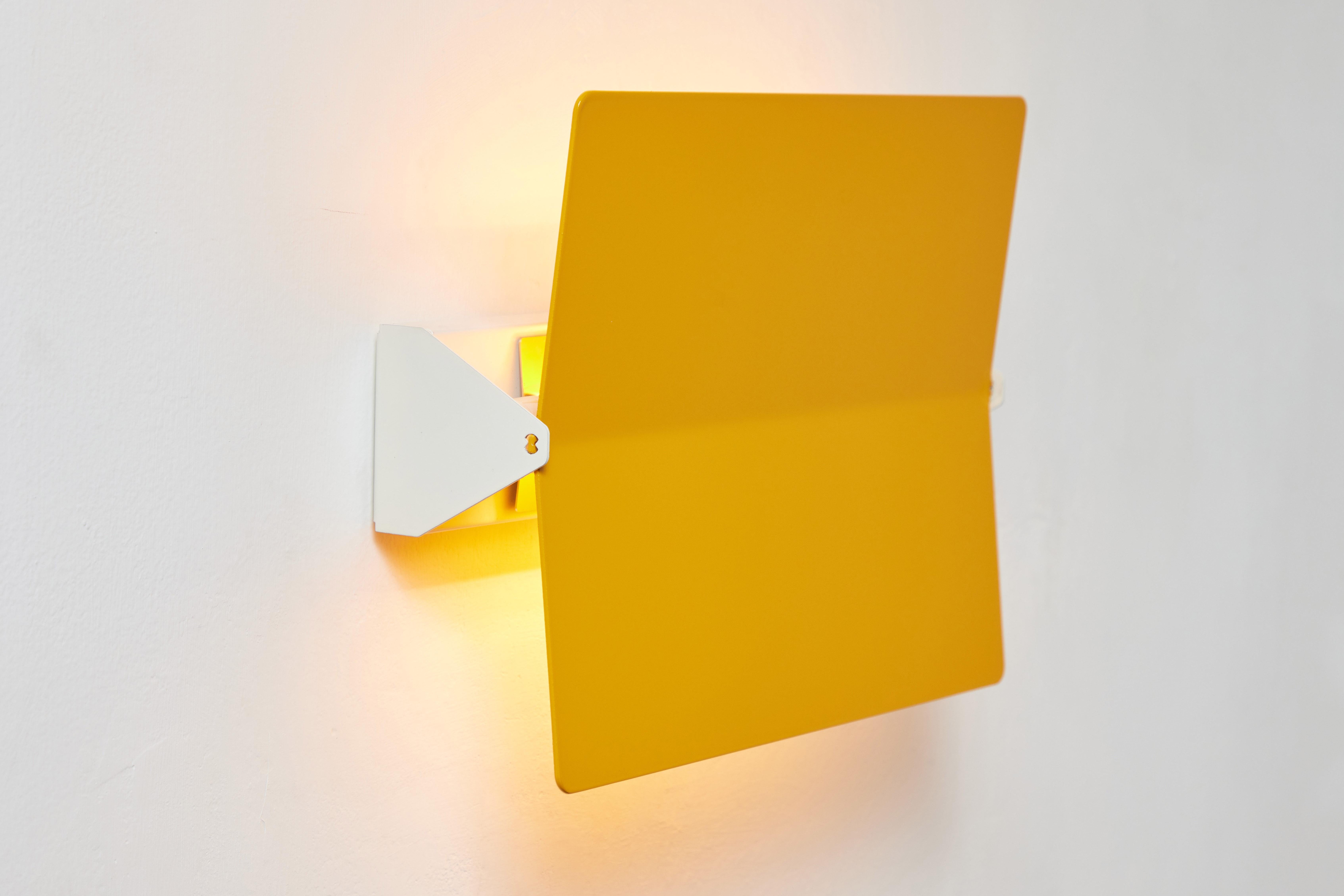 Large Charlotte Perriand 'Applique À Volet Pivotant Plié' wall light in yellow. 

Originally designed in the 1950s as the iconic CP1, these newly produced authorized re-editions are still made in France with the highest level of integrity and