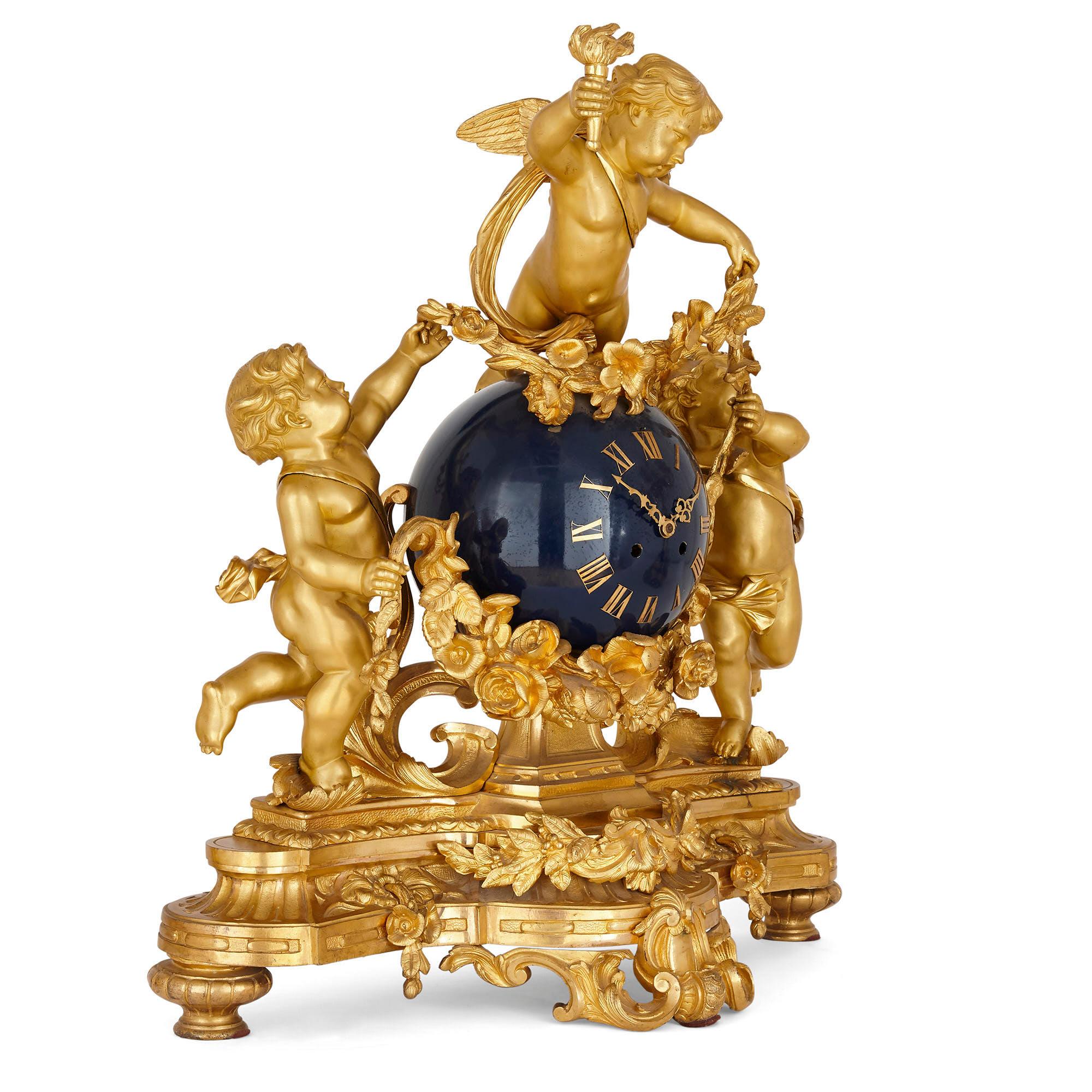 Large cherub-themed gilt bronze clock garniture by Popon
French, late 19th Century
Clock: Height 68cm, width 63cm, depth 26cm
Candelabra: Height 89cm, width 46cm, depth 39cm

This beautiful three-piece clock set is crafted from gilt bronze in