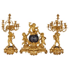 Used Large cherub-themed gilt bronze clock garniture by Popon