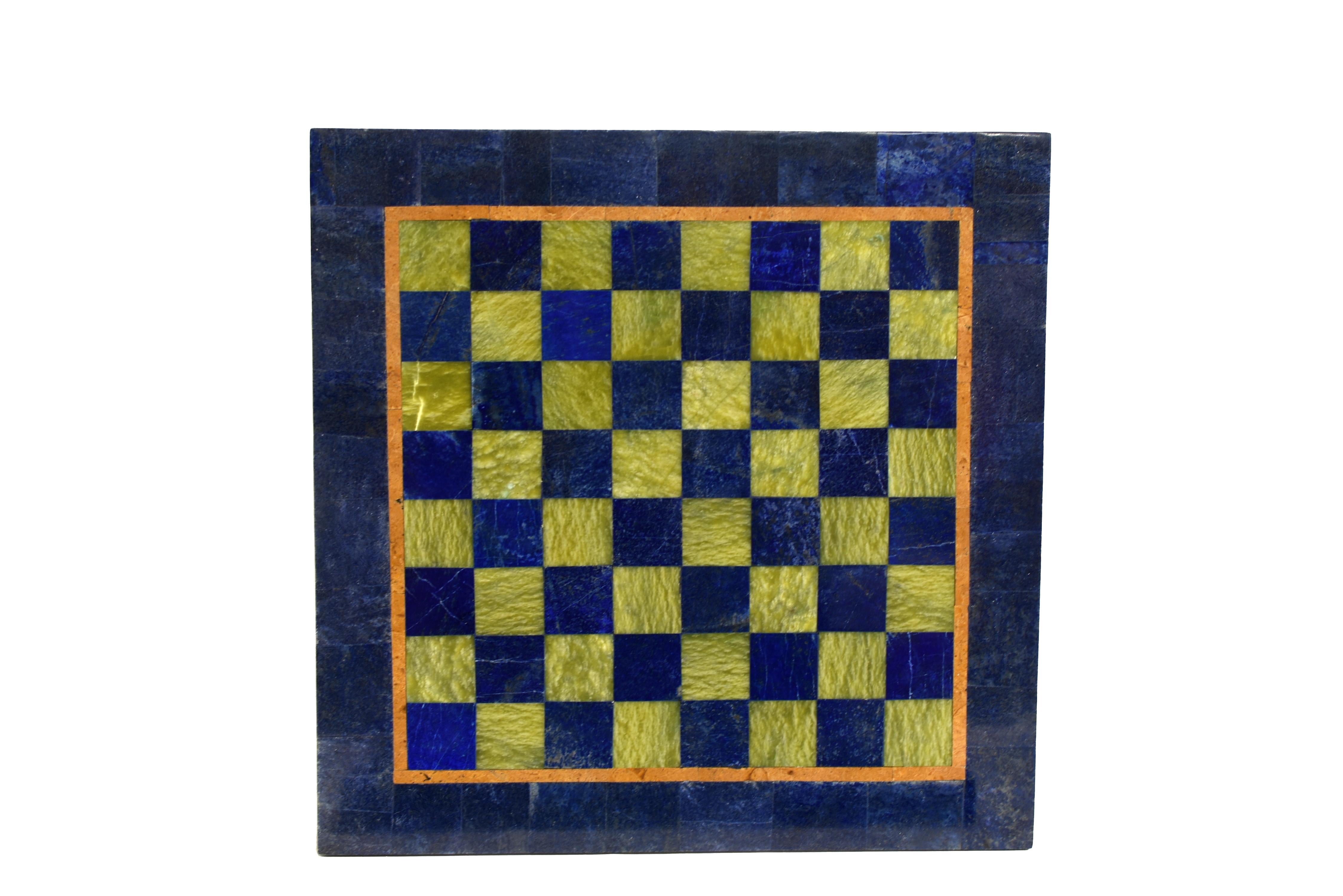 This large, one of a kind gemstone chess set is a stunning testament to traditional craftsmanship and unparalleled artistry. At its heart lies a magnificent lapis lazuli chessboard with hand-cut mosaic of blue lapis lazuli and verdant serpentine