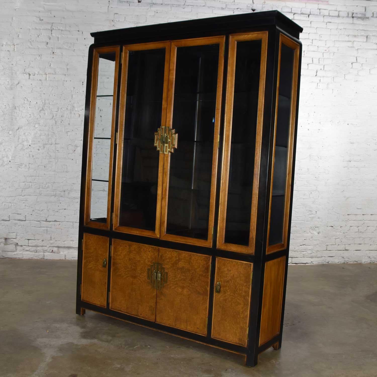 Gorgeous large Chin Hua china display cabinet or bookcase by Raymond K. Sobota for Century Furniture comprised of white ash burlwood with ebonized maple accents, brass hardware, glass shelves and lights. Wonderful vintage condition, a small repair