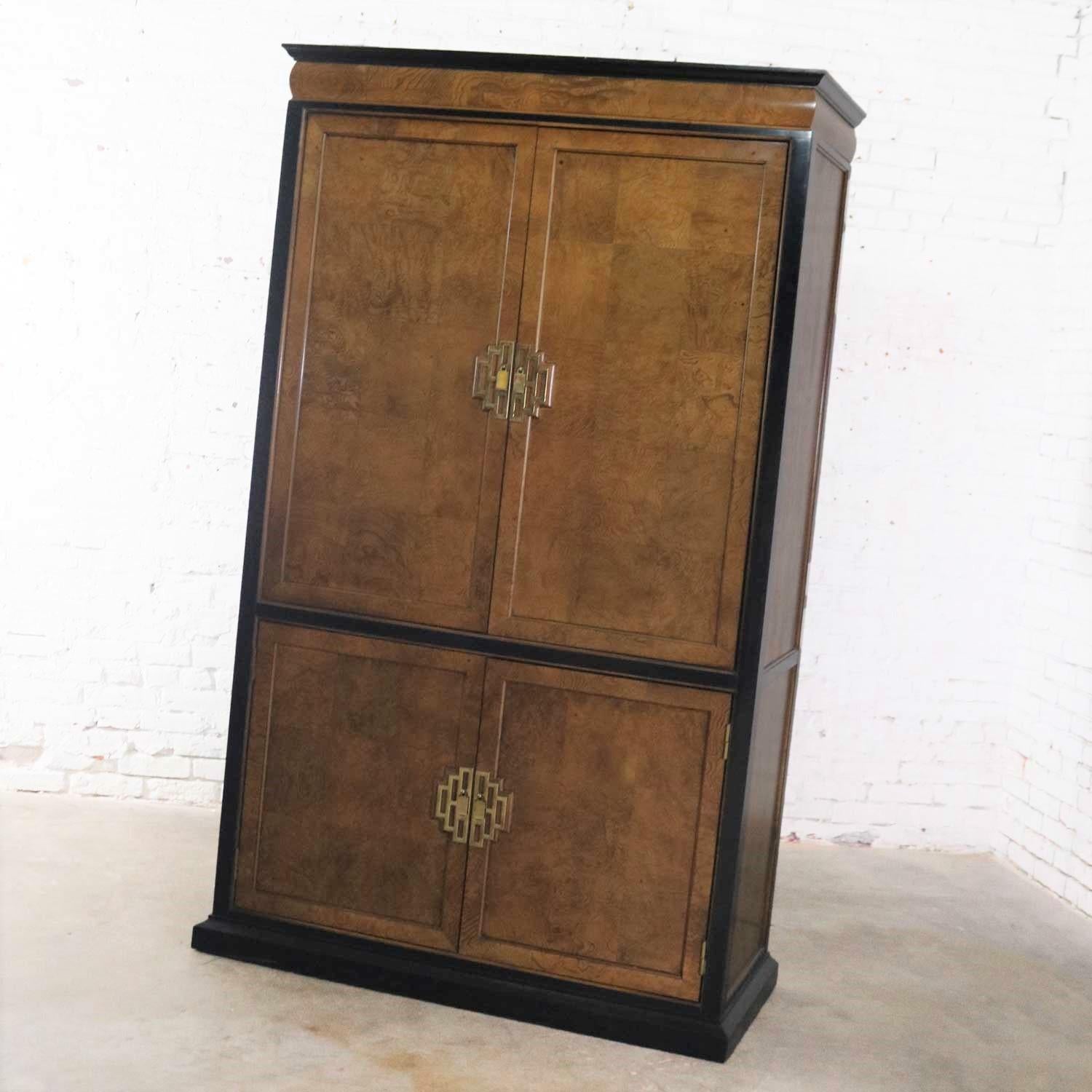 Incredible Hollywood Regency chinoiserie entertainment cabinet or storage armoire designed by Raymond K. Sobota for his Chin Hua collection for Century Furniture. It is in wonderful vintage condition overall. It does have normal signs of age and use